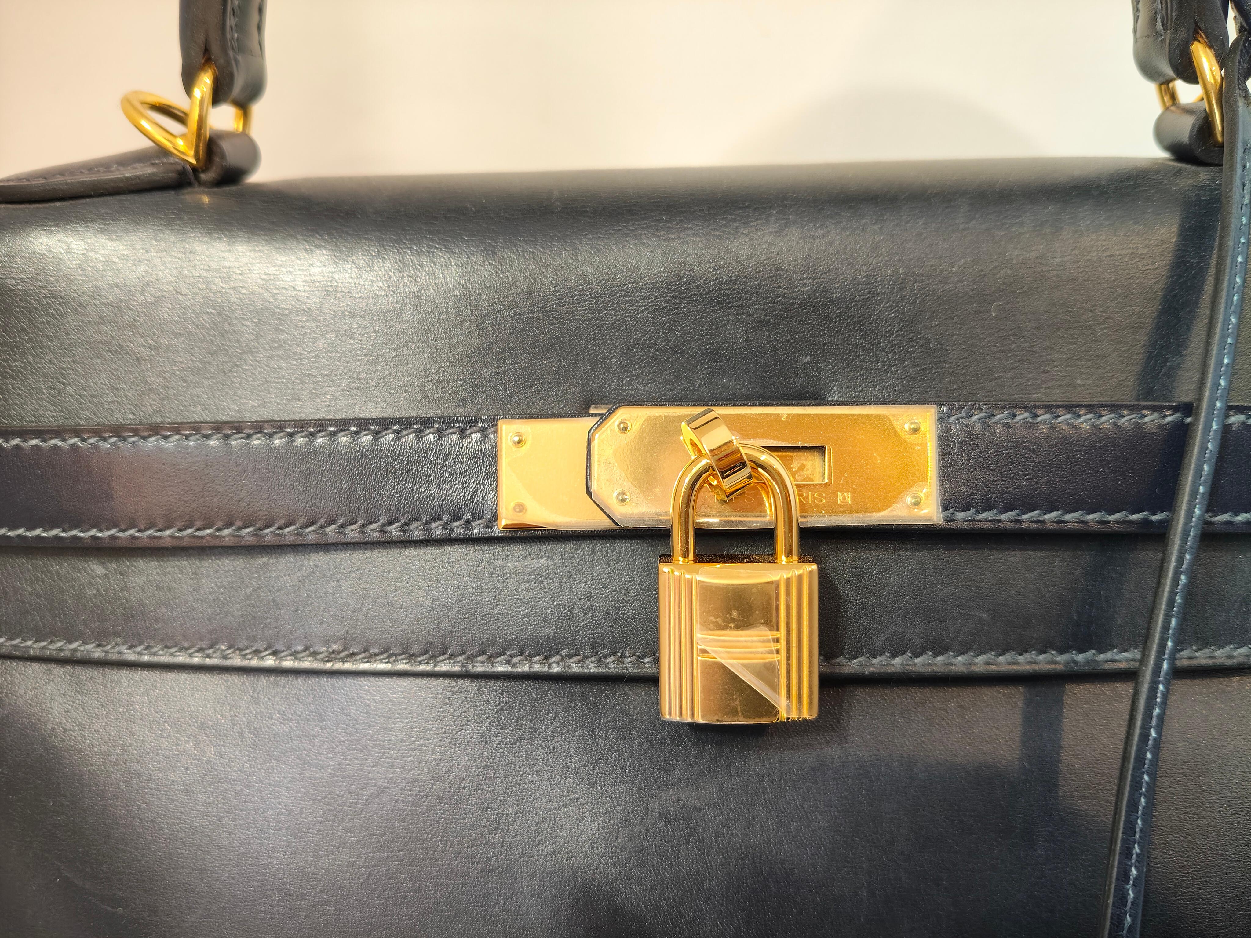 1992 Hermes Kelly 35 in dark Blue navy with Gold hardware. Hardware and shoulder strap have been replaced by Hermes. The bag comes with dustbag and new hardwares