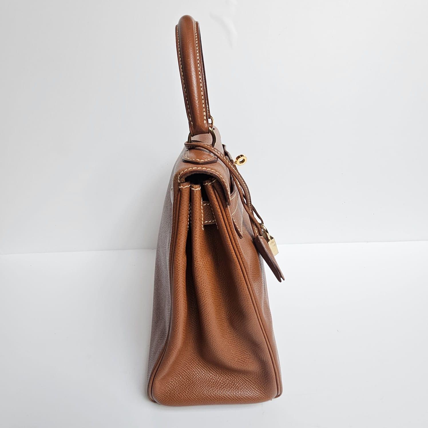 Vintage classic kelly 28 en cuir lisse (type epsom) couleur noisette. Une belle couleur neutre pour toutes les occasions. Légères éraflures et souplesses sur le cuir, mais en très bon état vintage. Légers frottements sur les coins et rayures