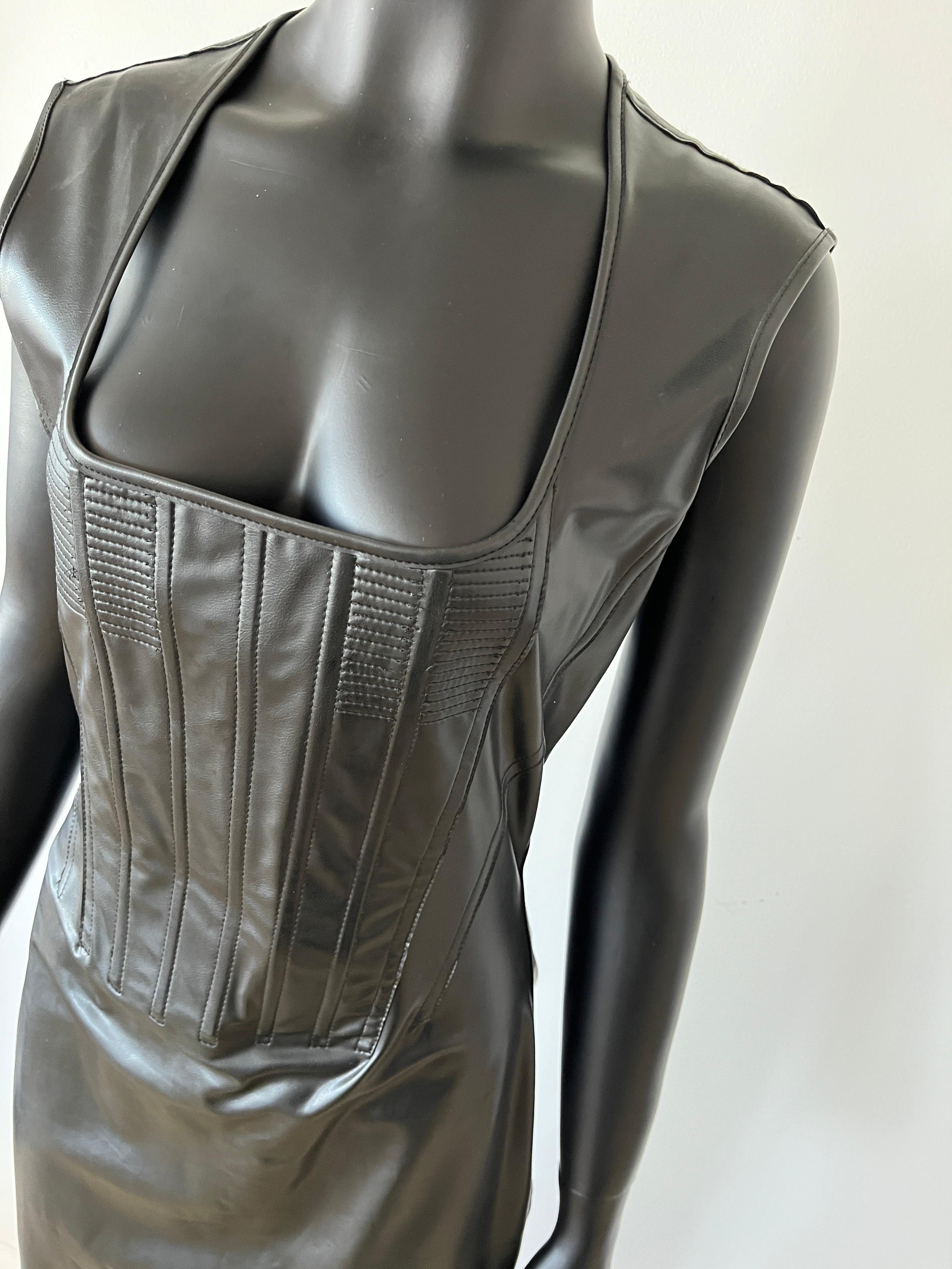 Iconic 1992 Jean Paul Gaultier Dominatrix Vinyl Skin Corset Zipper Bodycon Dress in black with lace up back.
A true collector's piece.

No size label but would fit small to medium. The lace and zipper make the sizing slightly adjustable.

Good