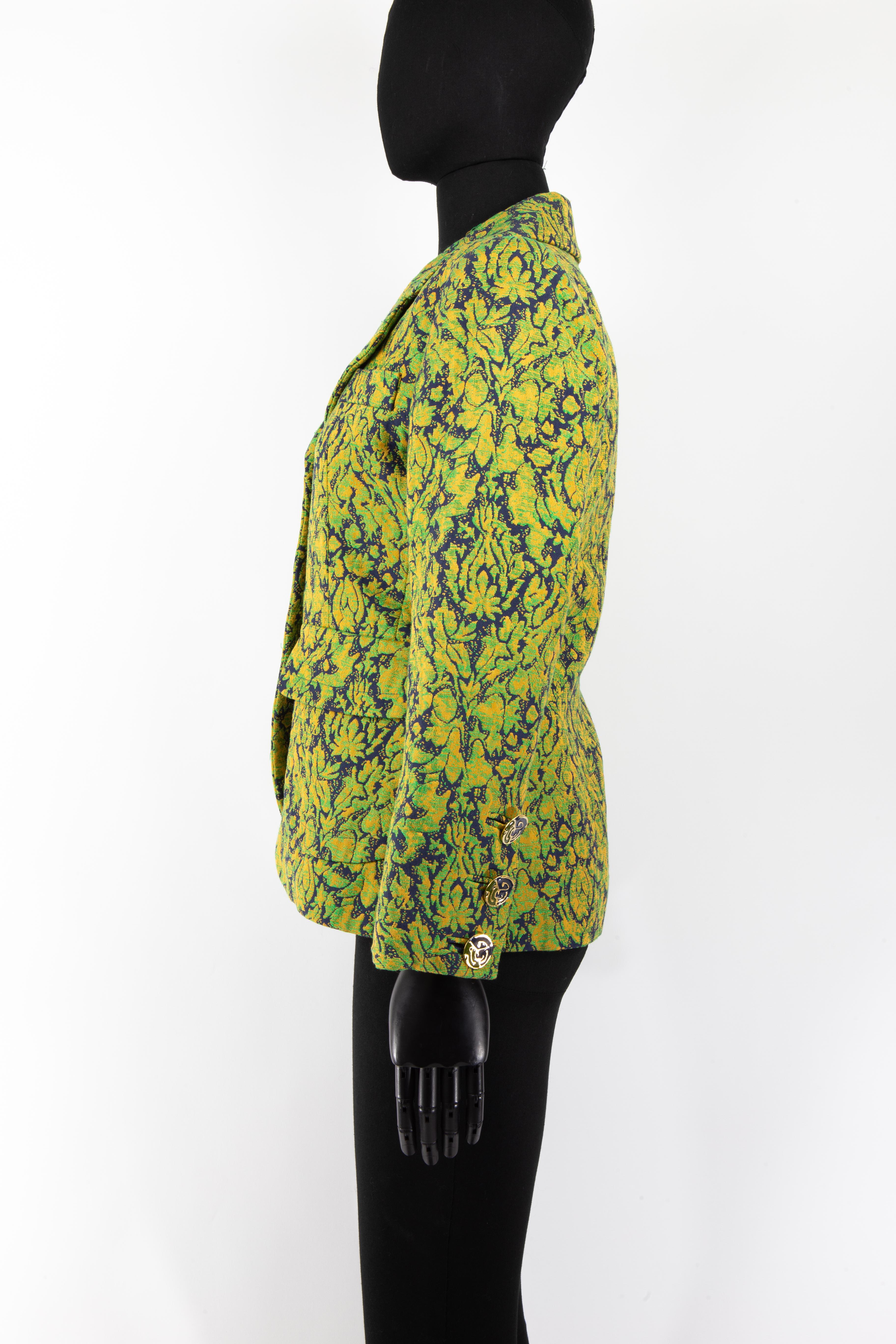 A 1992 Yves Saint Laurent navy, green and gold pattern jacket in a floral baroque taking an abstract theme. The front of the jacket is adorned with four enamelled buttons matching the theme of the pattern covering the jacket. These enamelled buttons