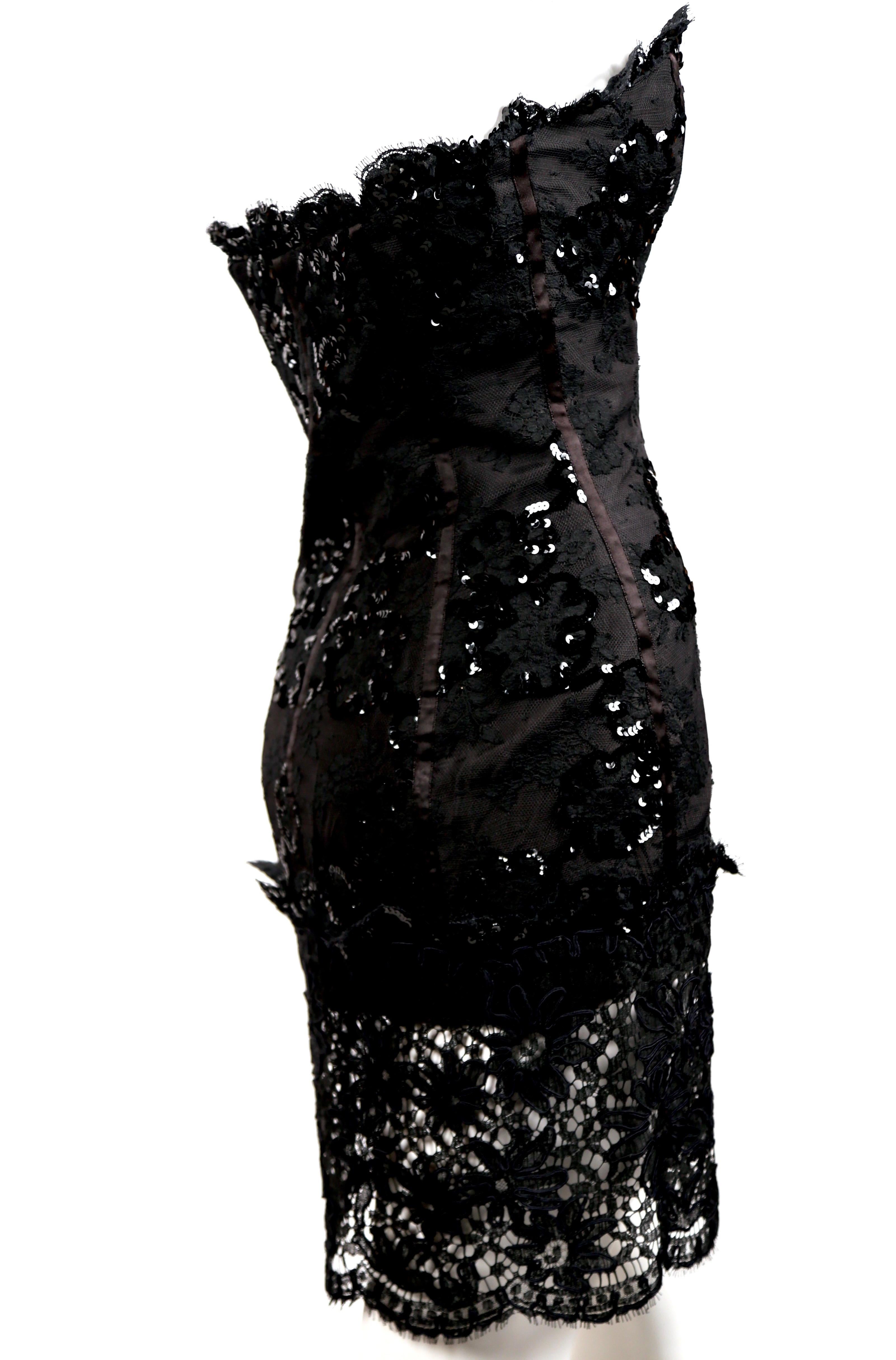 Jet-black, lace mini dress with sequins, bottom sheer panel and satin trim from Yves Saint Laurent dating to Spring of 1992. Dress is labeled a French size 38; however it would better fit a modern day size 34 or 36. Approximate measurements are: