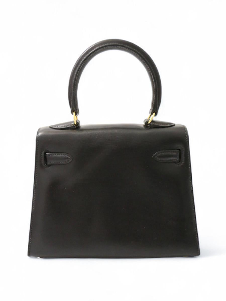 Vintage HERMES Mini Kelly black box leather in very good condition, with no signs of wear., delivered in its HERMES box. 
This rare model can be carried by hand or on the shoulder with its removable shoulder strap. It is a smaller version of the