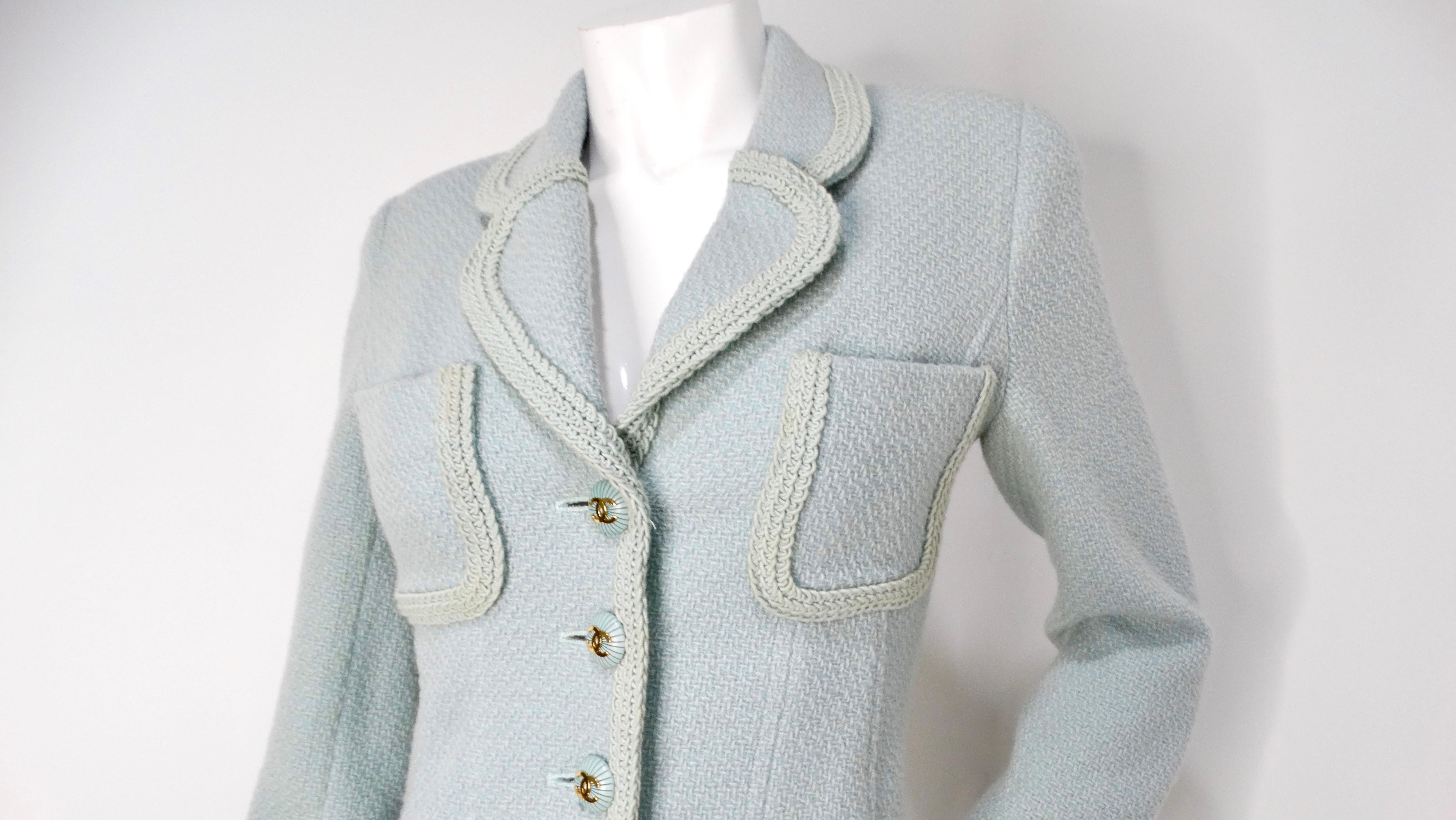 Introducing the iconic 1993 Chanel Mint Pastel Blue Tweed Jacket, a timeless piece that embodies the essence of luxury and sophistication. Adorned with the exquisite interlocking CC logo buttons, this jacket exudes an air of elegance that is