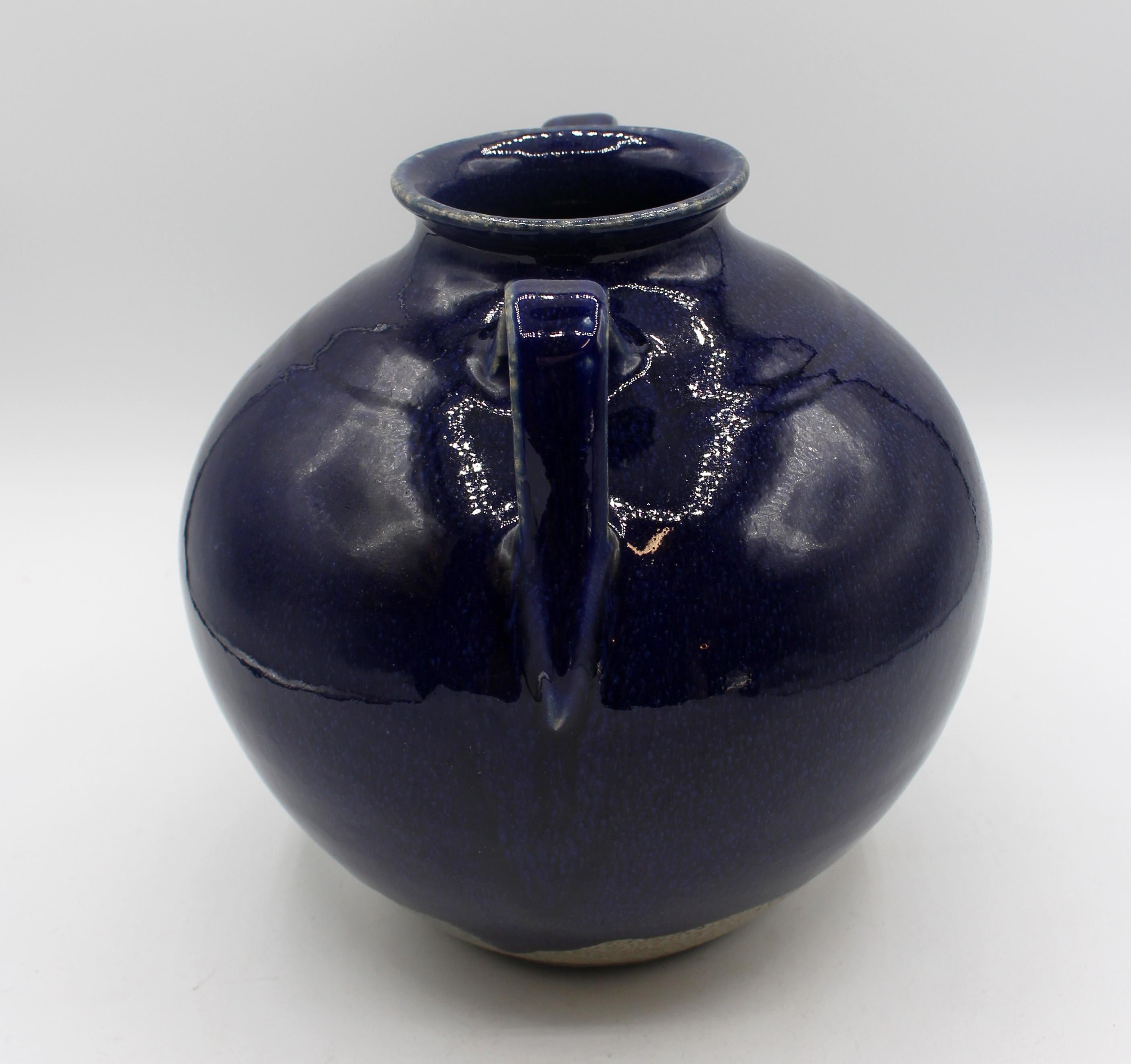 1993 Cobalt blue glazed double loop handled pottery jar or vase by Vernon Owens. Jugtown Ware, Seagrove, NC. The thick cobalt glaze drips down a salt glazed body. 8 3/4