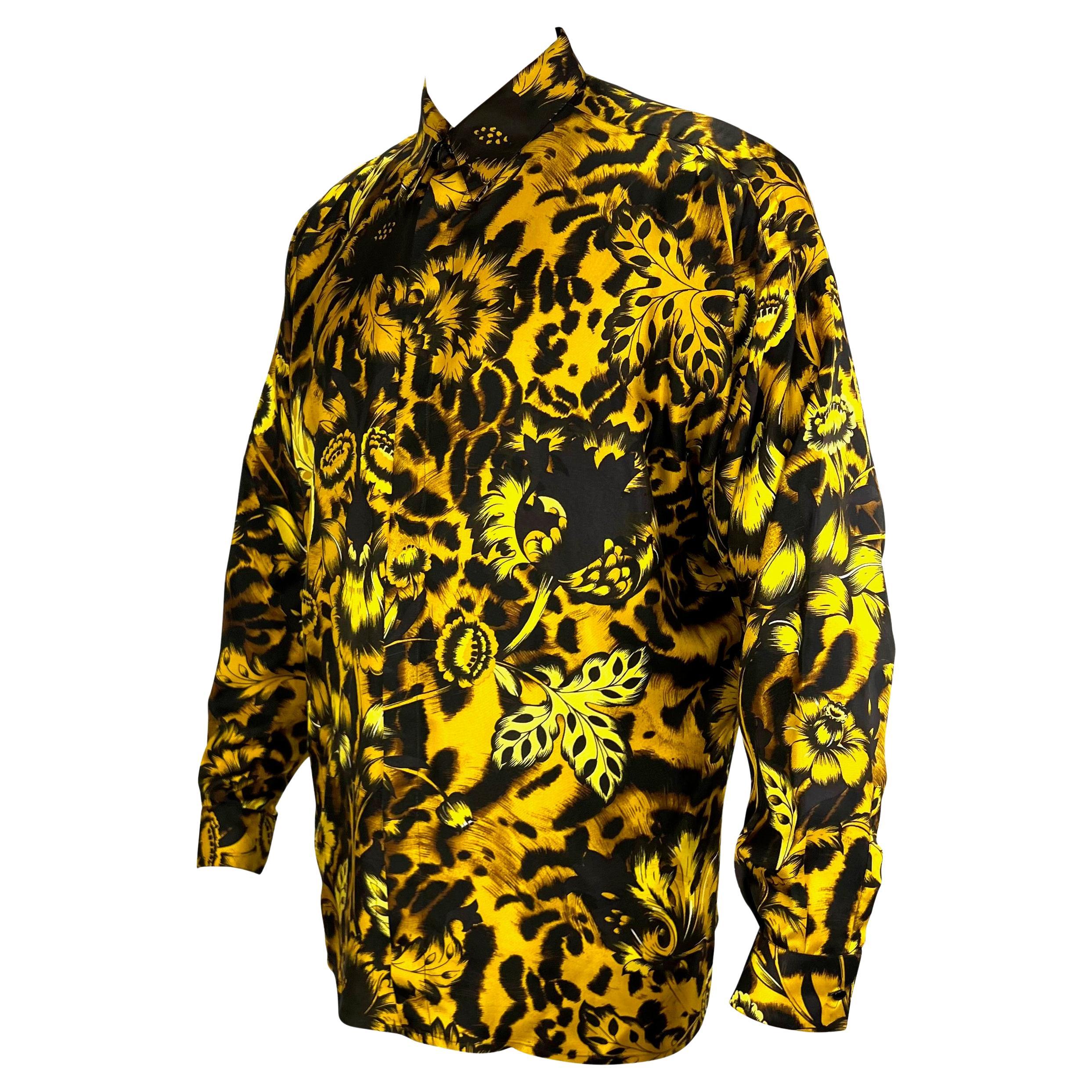 TheRealList presents: an incredible men's silk animal print floral Gianni Versace shirt, designed by Gianni Versace. From 1993, this amazing and soft shirt features a black and yellow floral and animal print throughout. This bold shirt is made