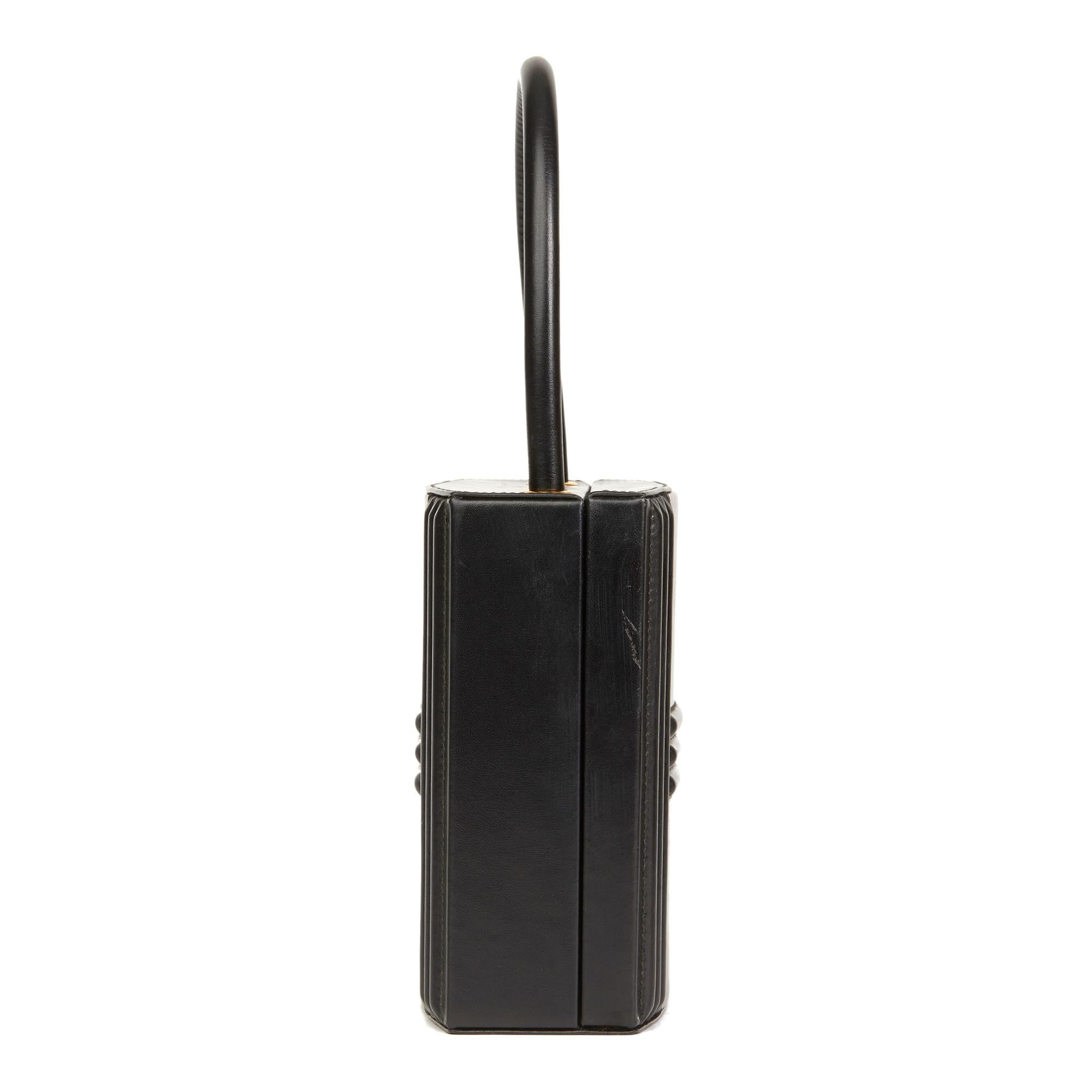 HERMÈS
 Black Box Calf Leather Vintage Cadena Bag

Reference: HB2643
Serial Number: (W)
Age (Circa): 1993
Accompanied By: Hermes Dust Bag
Authenticity Details: Date Stamp (Made in France)
Gender: Ladies
Type: Top Handle

Colour: Black
Hardware: