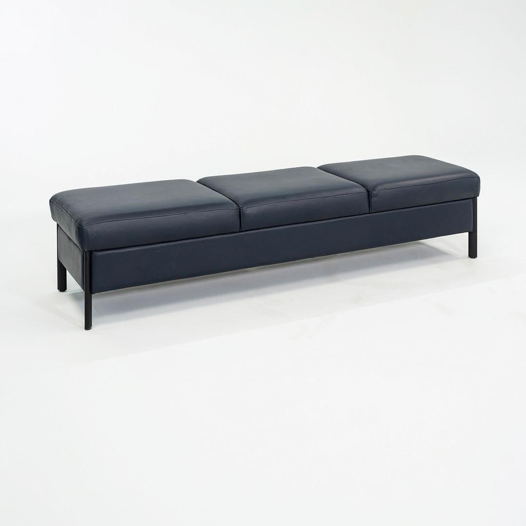 This is a 3-Seat Leather Bench produced by Metropolitan Furniture in the USA. The exact designer of this piece is unknown. The bench's design is comprised of a wooden frame, metal legs, and it's upholstered in a dark blue leather. 
 
 The bench