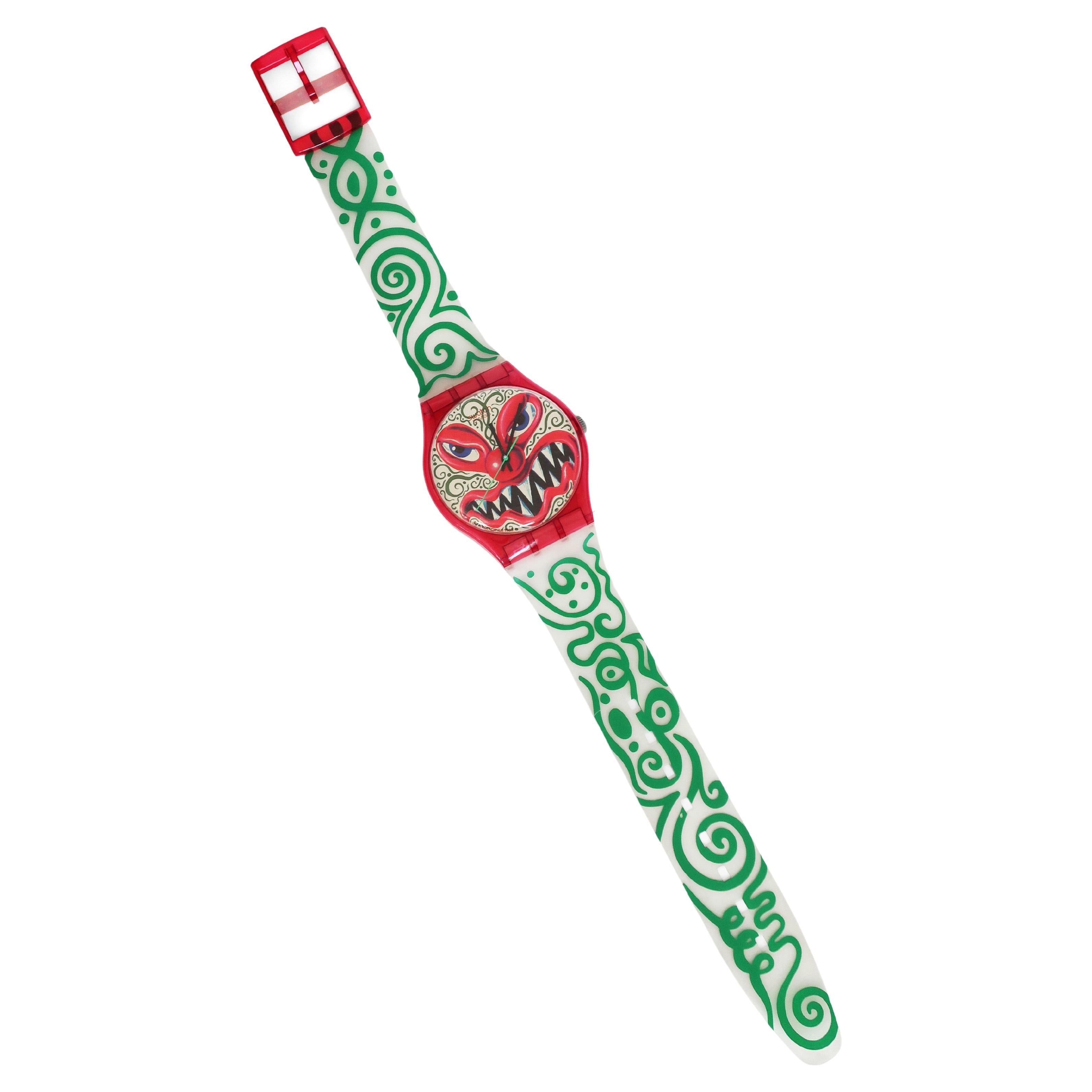A charismatic and sinister design from 1993 by American artist Kenny Scharf for Swatch. Produced as a wristwatch and also in this Swatch Maxi over-sized seven foot tall wall clock version. Scharf's work is humorous, pushes boundaries, and is always
