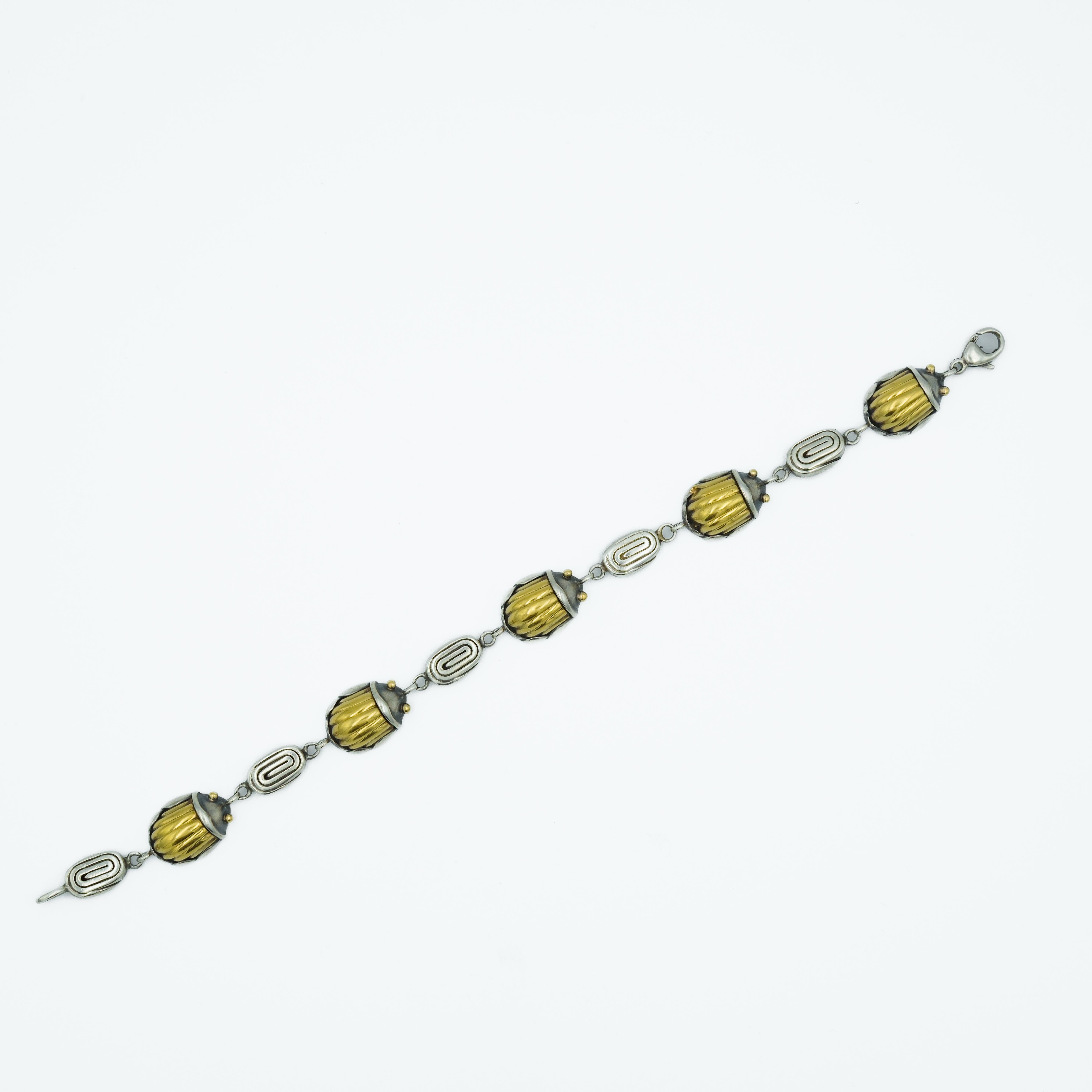 This Tiffany & Co. bracelet, created in 1993, is a distinguished piece that reflects the company's timeless elegance combined with the cultural influences of the early 1990s. Crafted from 925 sterling silver and accented with 18k yellow gold, the
