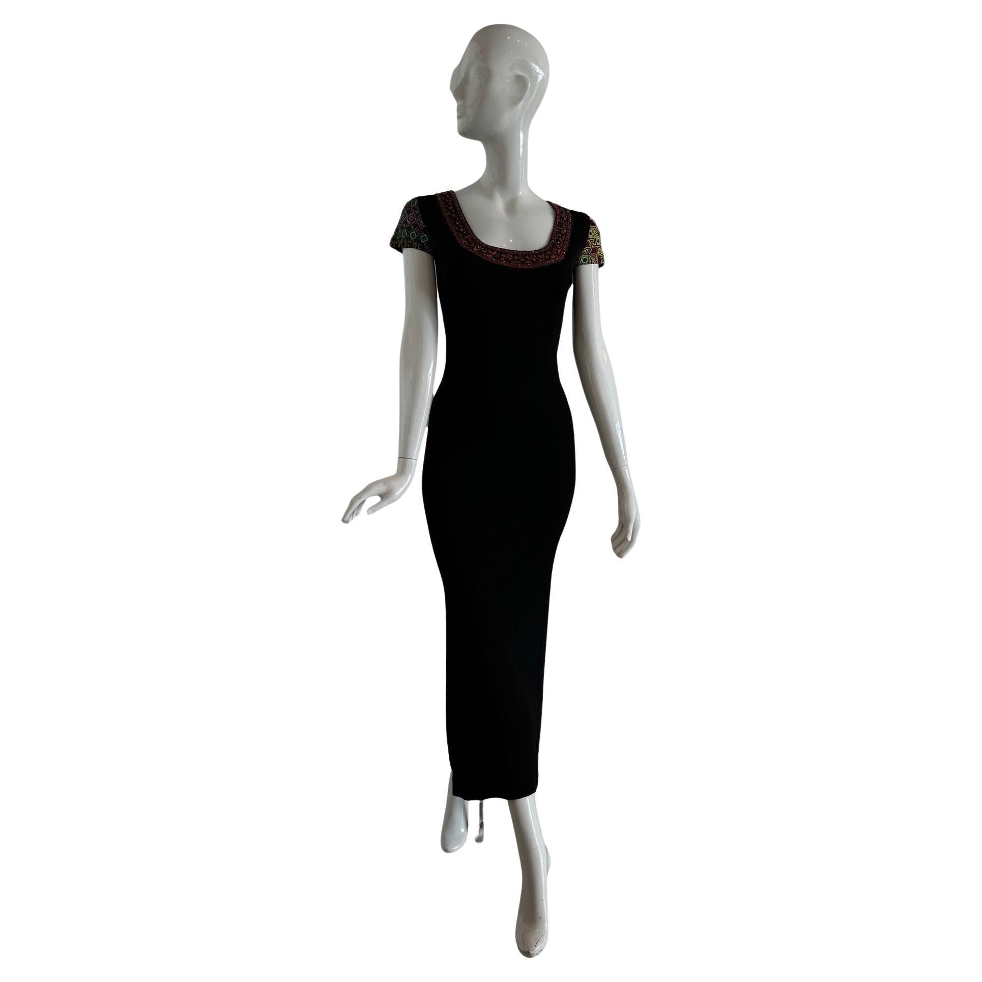 From the 1993 SS Runway collection is this INSANE black 90s fitted gown with detailed heavily beaded collar and sleeves.  

The beading and embroidery on one sleeve is done in swirled yellow and black with green/blue and red/blue embroidered circles