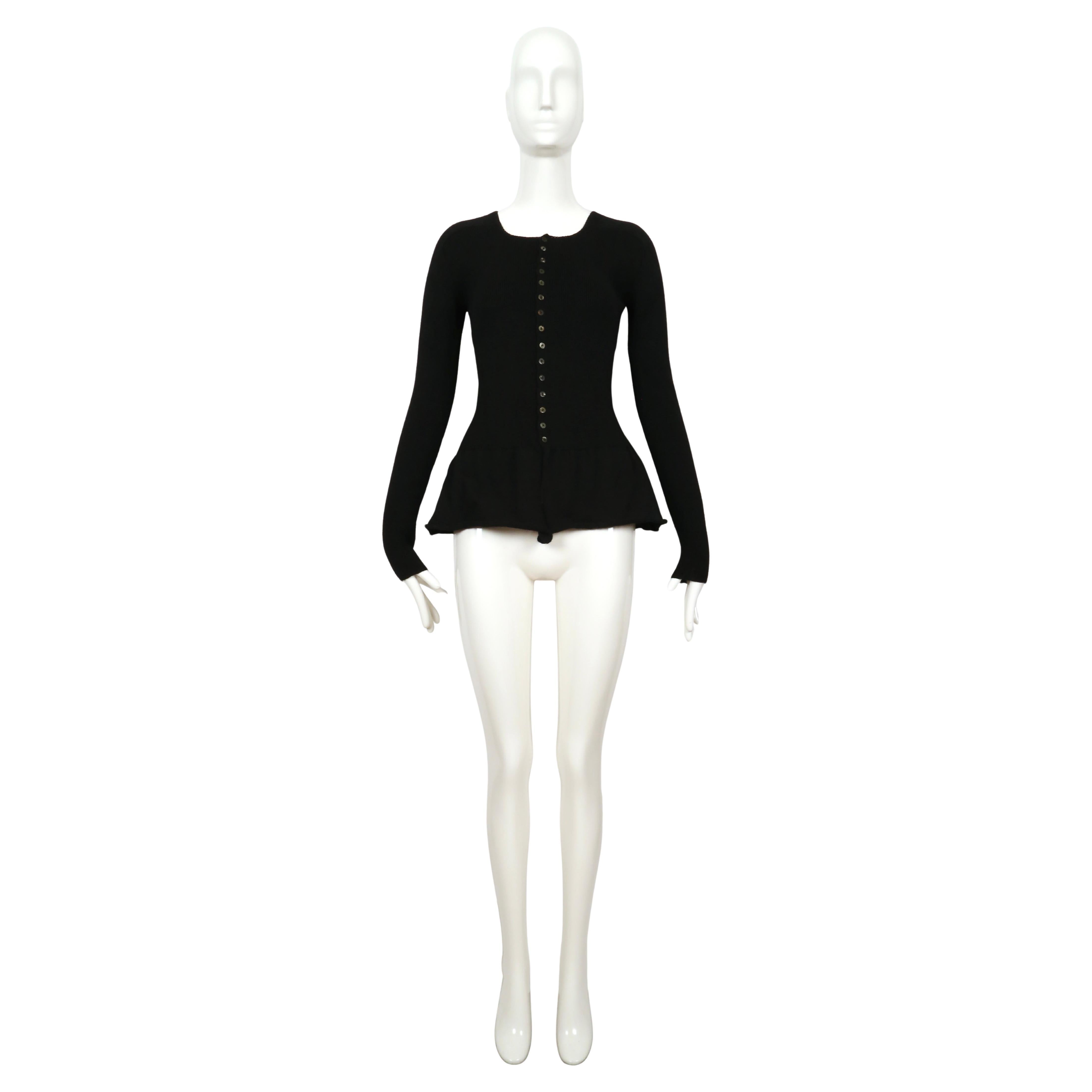 Jet black ribbed wool sweater with peplum designed by Yohji Yamamoto dating 1993.  Size 'M' however this best fits a XS or S.  Approximate measurements (unstretched): bust 30