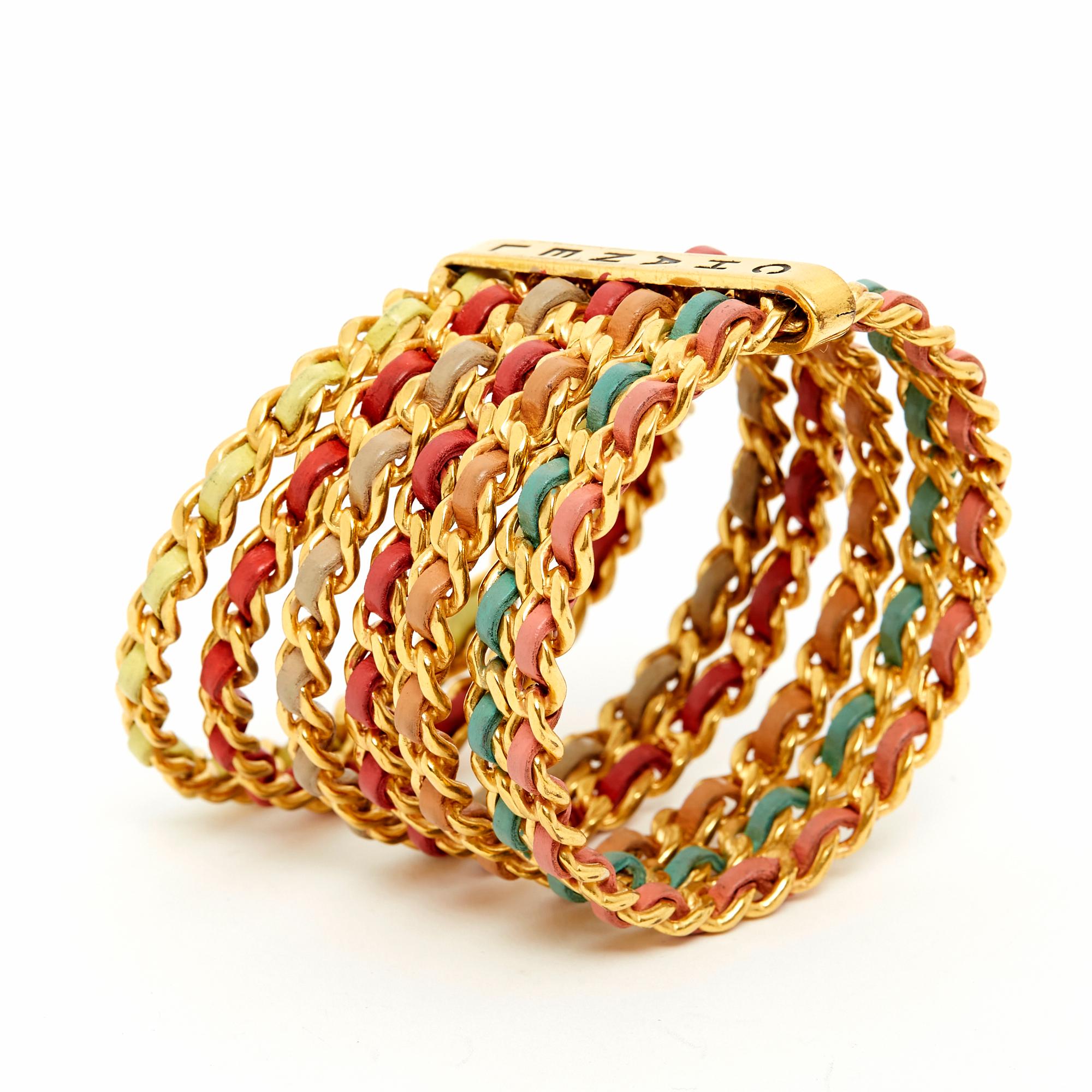 Chanel bracelet from the 1993 Cruise collection composed of 7 bracelets in a rigid gold metal chain interwoven with leather in different pastel colors, held together by a Chanel-engraved metal band. Inner diameter of the bracelets approximately 7