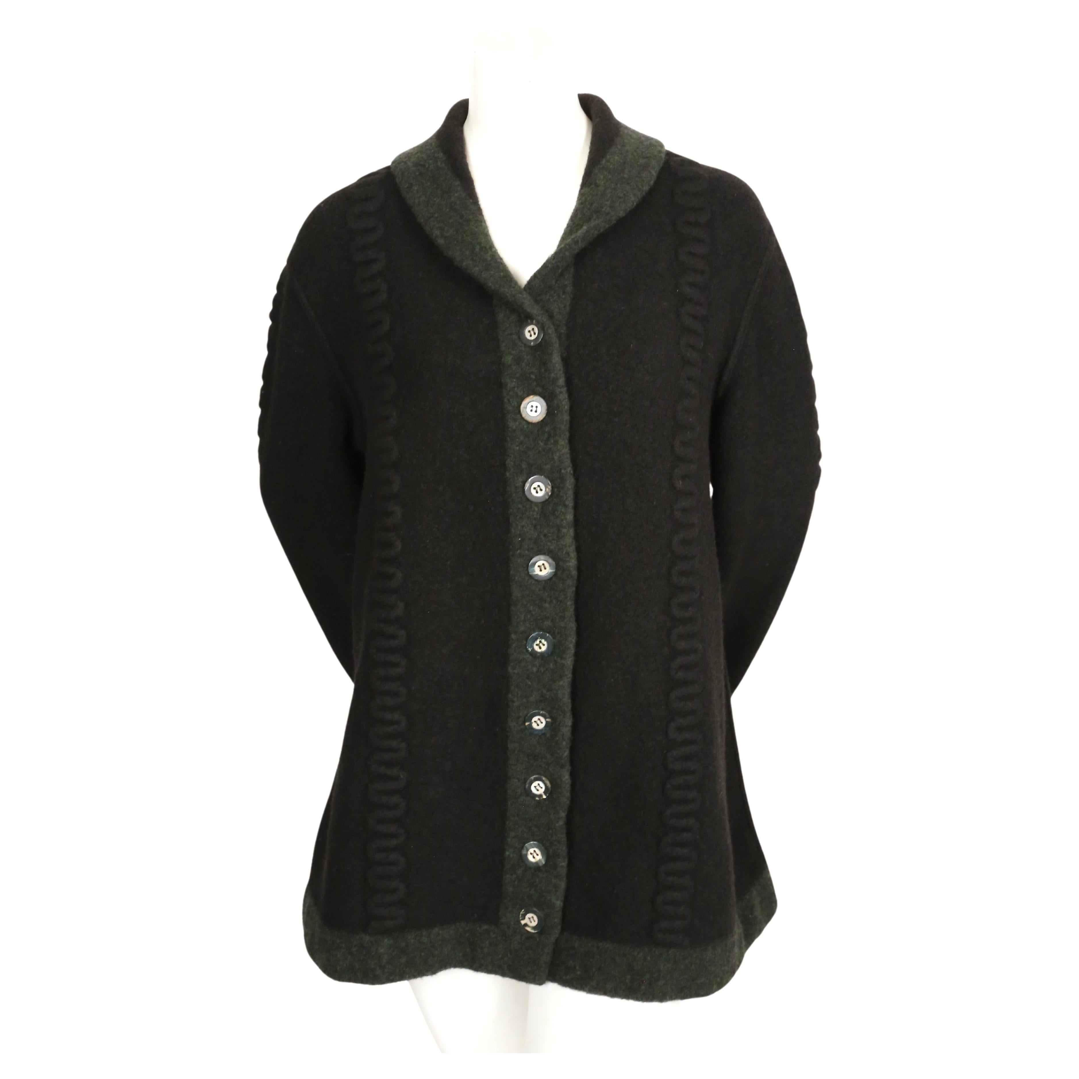 Deep navy-blue and green oversized wool sweater with raised weave and shell buttons designed by Azzedine Alaia dating to fall of 1994. Labeled a size 'S' however this is very oversized so it fits many sizes. Has an A line fit. Approximate