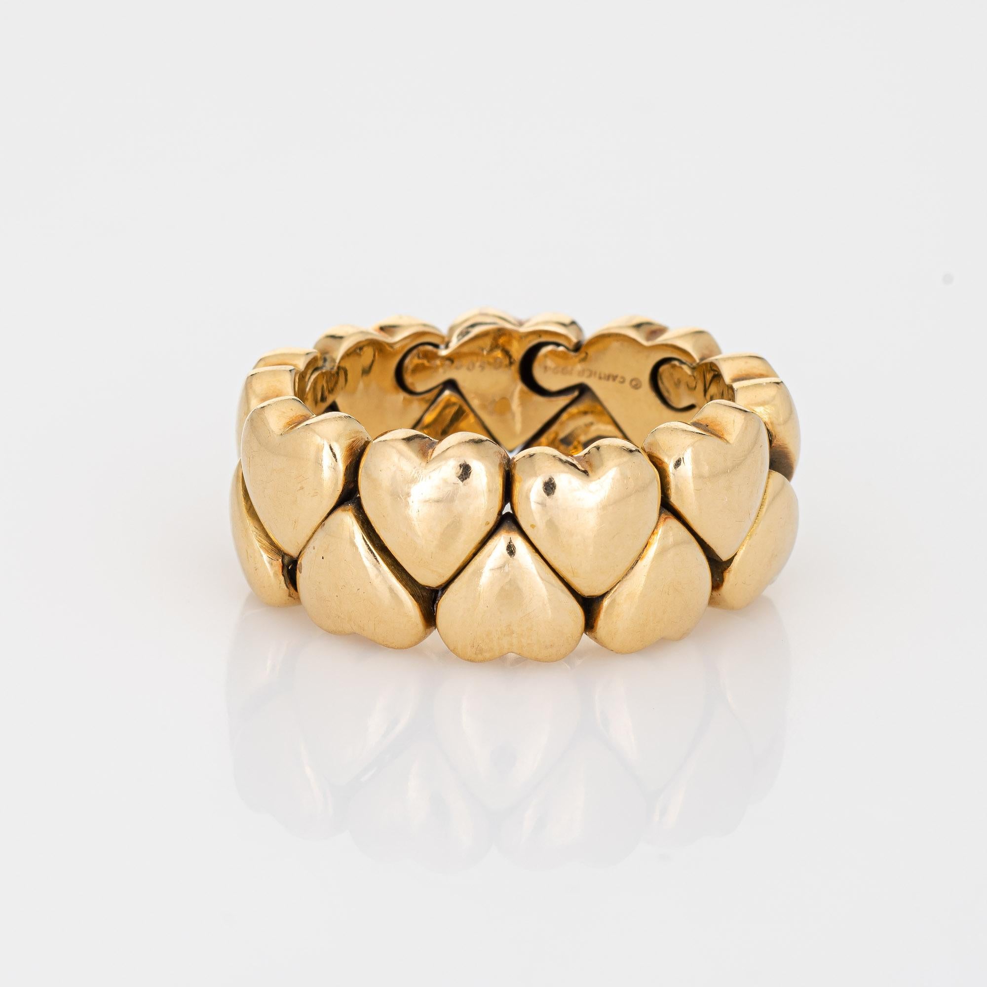 Out of production vintage Cartier heart band ring crafted in 18k yellow gold (circa 1994).  

The Cartier ring features a flex design that melds to the shape of your finger. The wide band measures 10mm (0.39 inches). The ring is great worn alone or