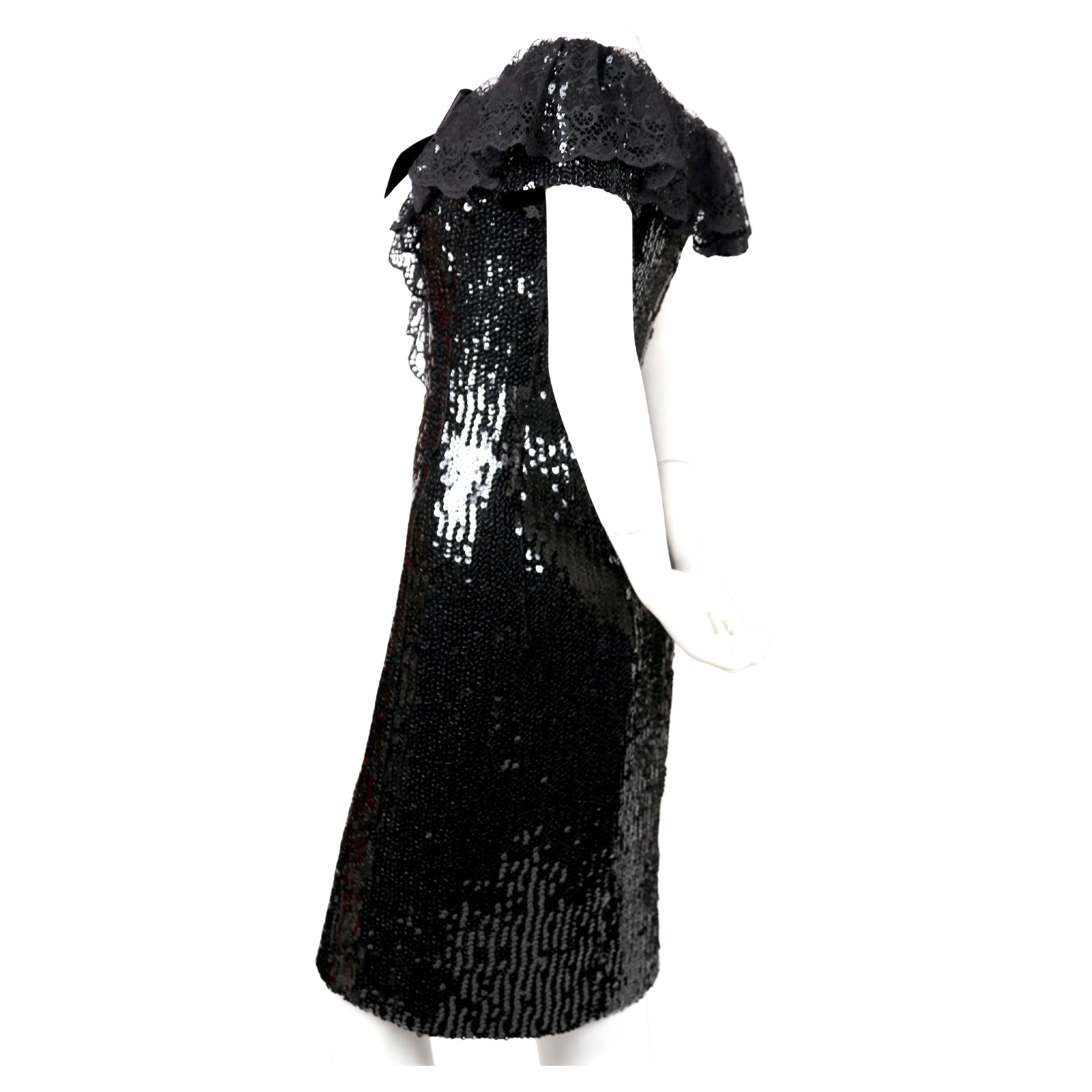 Jet-black sequined dress with chantilly lace collar and black satin bow from designed by Karl Lagerfeld for Chanel dating to fall of 1994 as seen on the runway. Size label has been removed. Best fits a US 4-6. Approximate measurements: bust 34