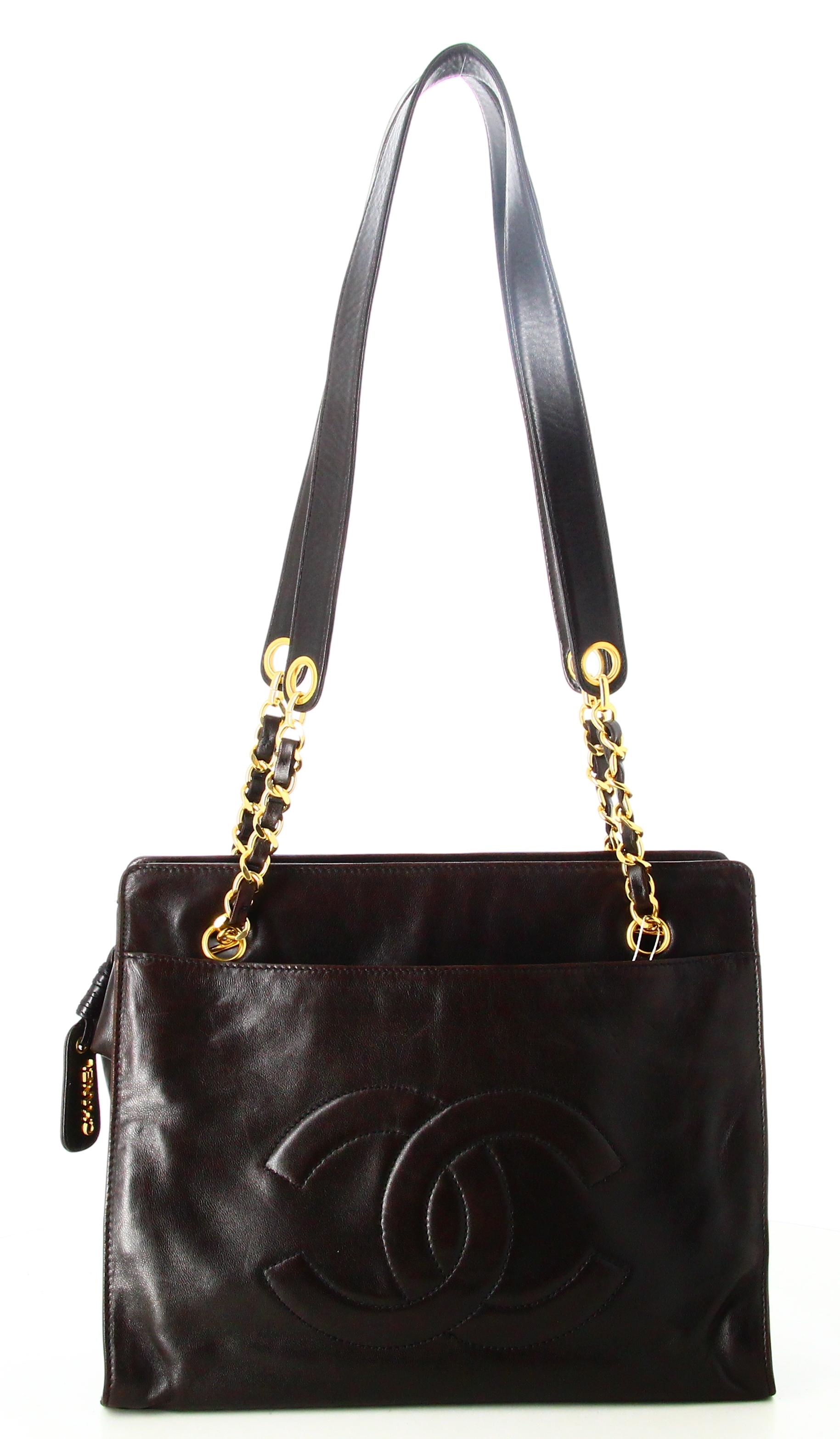 1994 Chanel CC Chain Tote Bag

- Very good condition. Shows very slight signs of wear over time. 
- Chanel Handbag
- Two black leather straps 
- Double C on the front 
- One pocket on front and back 
- Golden zip fastening 
- Inside: black fabric