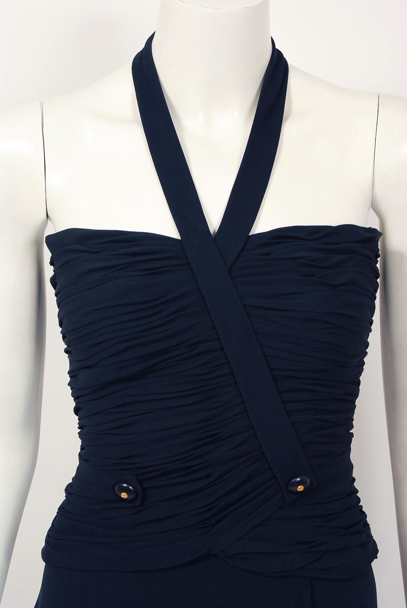 Chanel is known to be one of the most luxurious and decadent fashion houses in the world. This gorgeous navy-blue silk chiffon ensemble from their iconic 1994 collection is a perfect example of why this couture brand has stood the test of time. Not