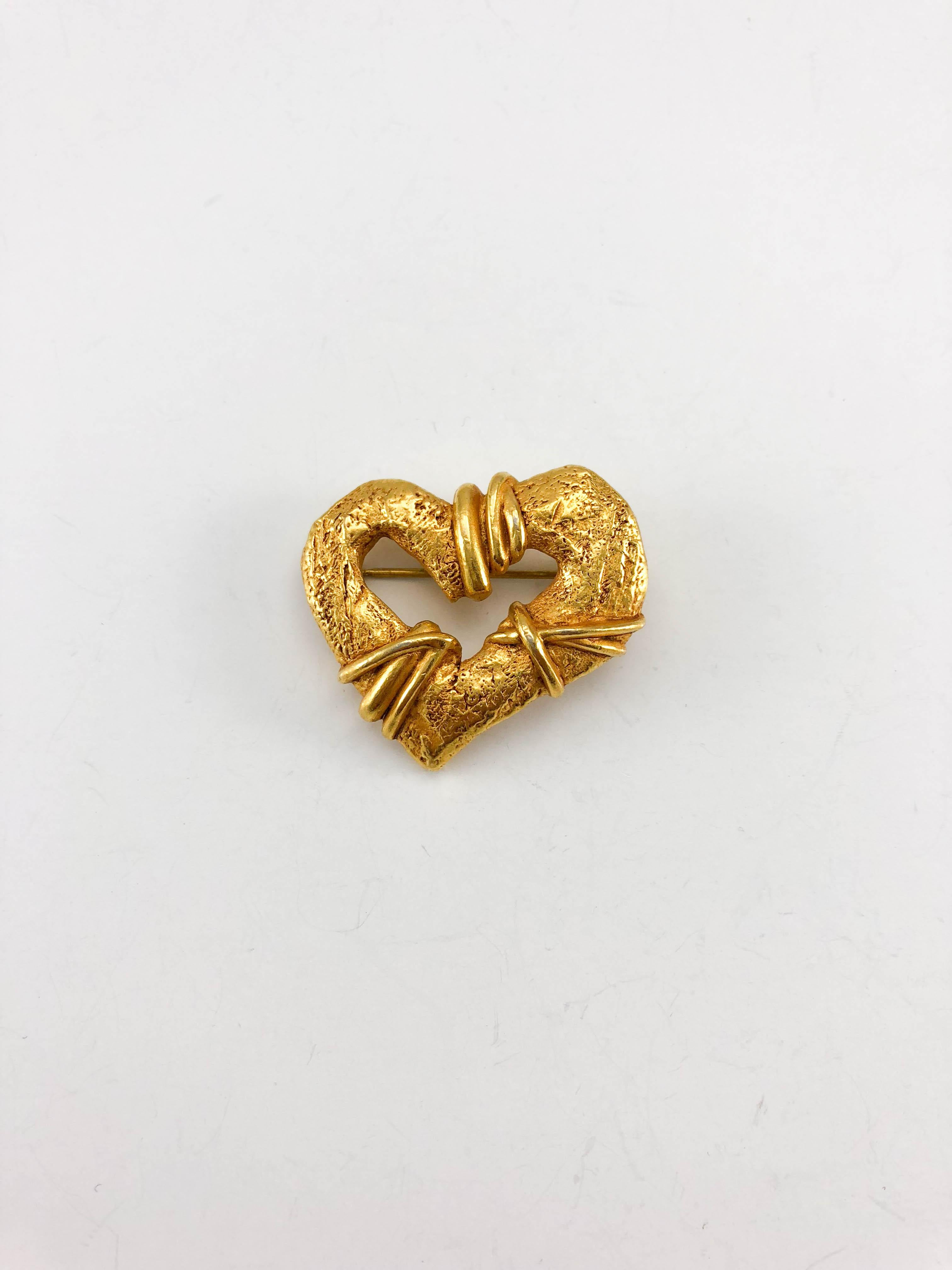 Vintage Lacroix Gold-Plated Heart Brooch. This beautiful brooch by Christian Lacroix was crafted for the 1994 Spring / Summer Collection by Robert Goossens. Made in gold-plated metal, it is shaped like a heart. The look and feel are organic.