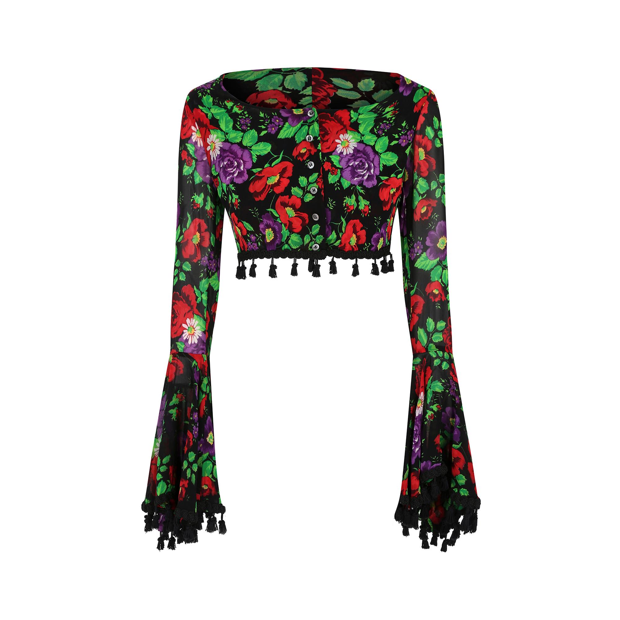 Rare and early Dolce and Gabbana cropped floral blouse from the spring summer 1994 collection.  It has these extraordinary trumpet sleeves that are edged in passementerie black trim with little toggles which are also echoed around the neck. The