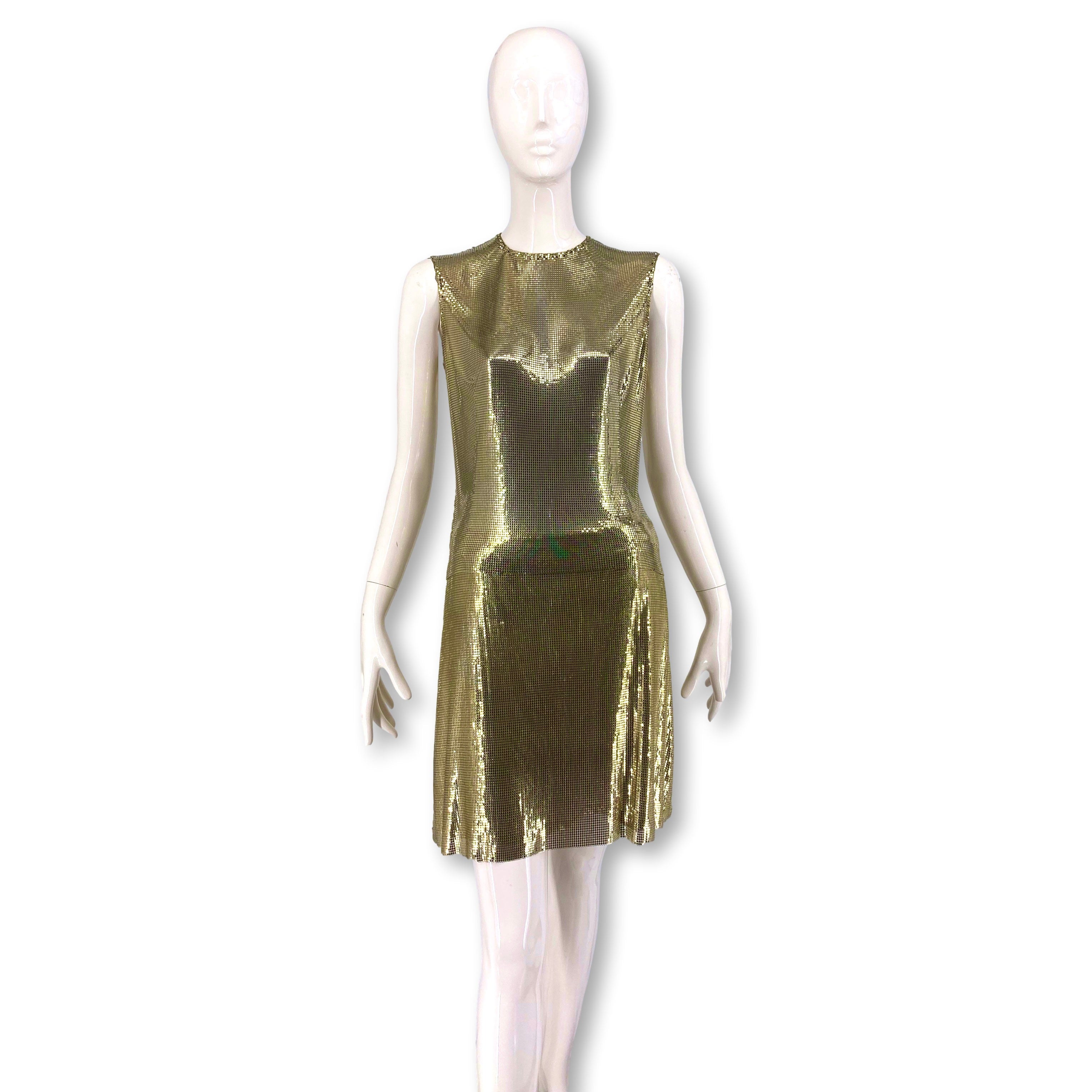 A rare 1994 F/W Gianni Versace Couture gold metal Oroton chainmail top and skirt ensemble - seen on the model Amber Valetta in listing photo #4 - an editorial photo of the collection from 1994. The 2-piece can be worn as separates or with the