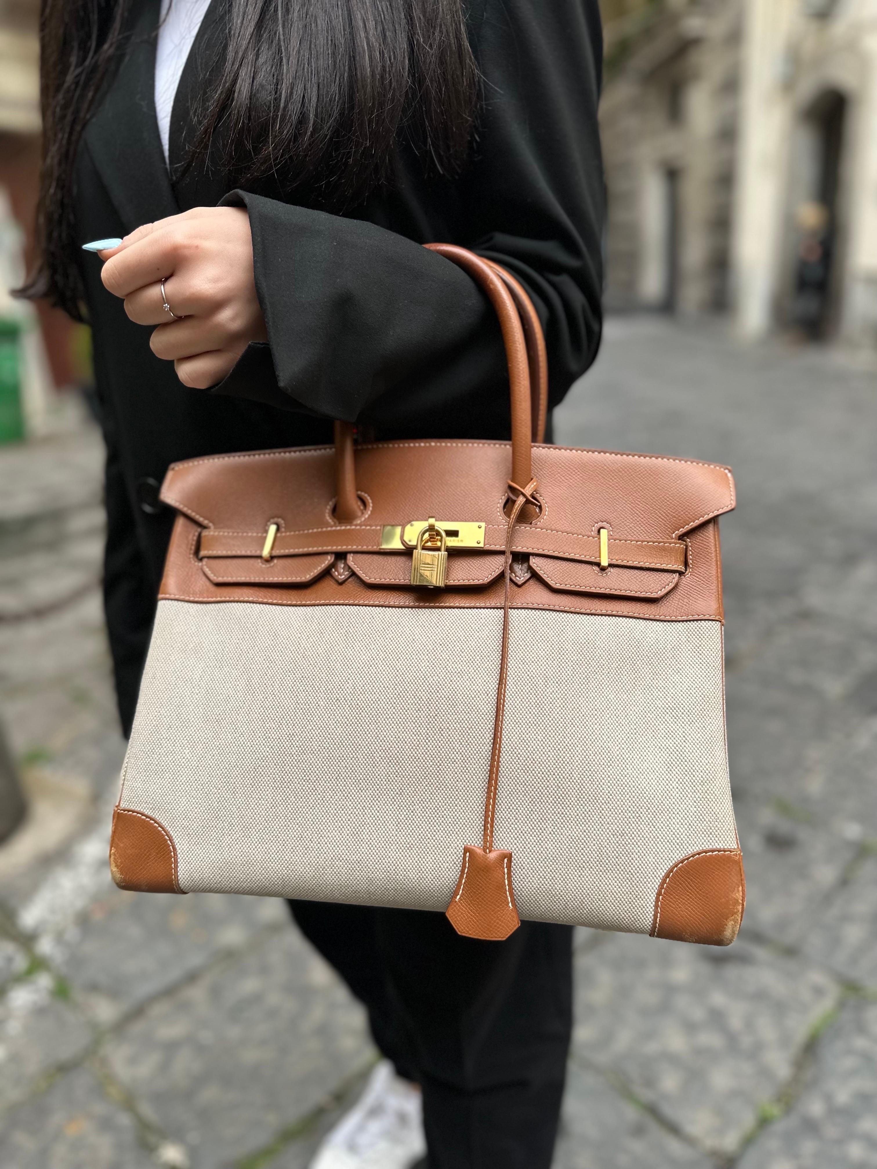 Hermès bag, Birkin model, size 35, made in two materials: the upper part in Epsom leather, rigid to the touch with fine grain, Gold color and the lower part in beige canvas. Equipped with the classic interlocking flap, with horizontal band closure,