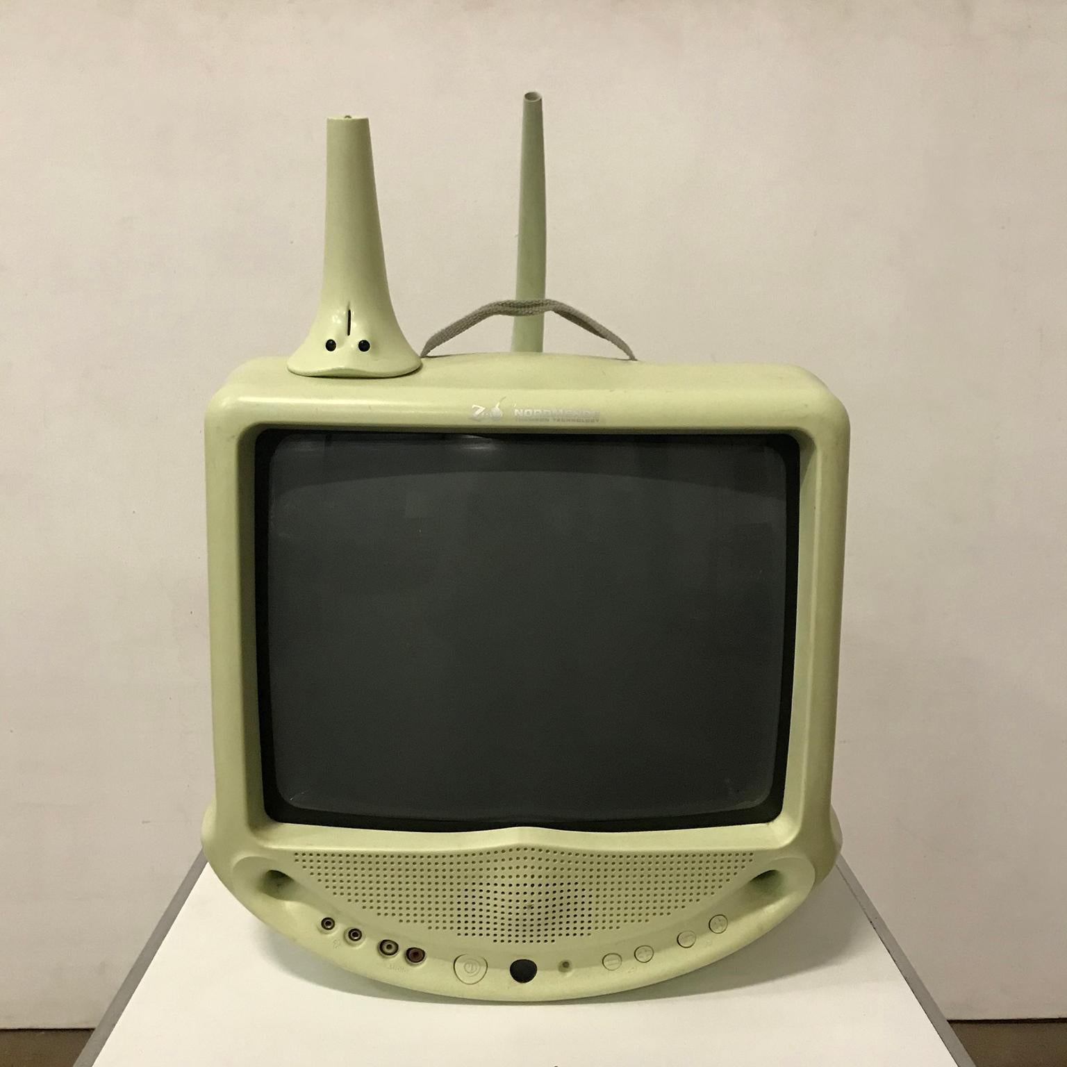 Portable Nordmende television by Thomson Technology with remote control in pastel pistache. Very charming design. The set is functioning. The television is portable by a handle/band. This portable TV set raises numerous interesting points due to its