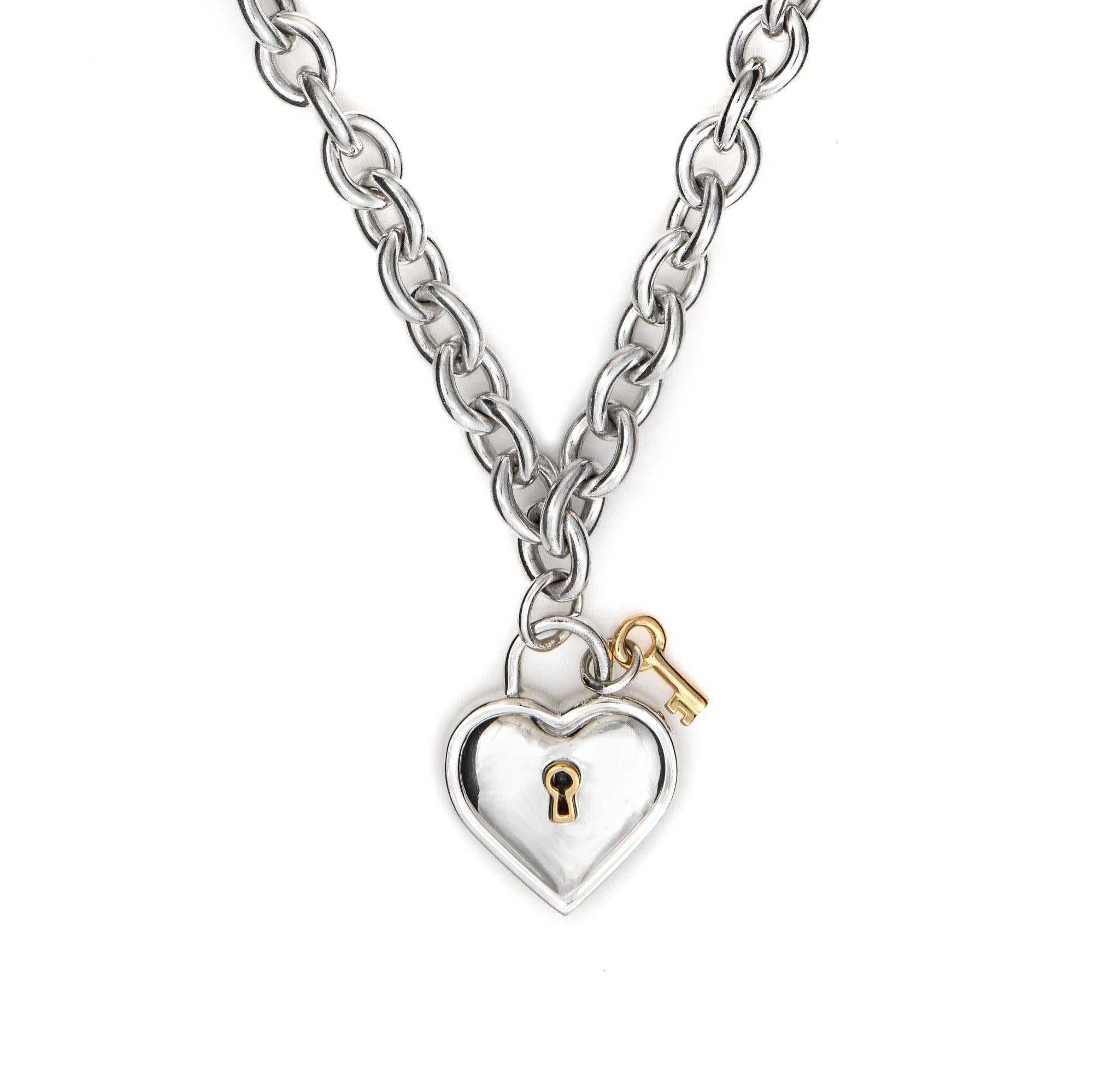 Stylish and finely detailed vintage Tiffany & Co heart key lock necklace, crafted in sterling silver & 18 karat yellow gold (circa 1994).  

The necklace features a heart with key charm crafted in 18k yellow gold. Measuring 16 inches in length the