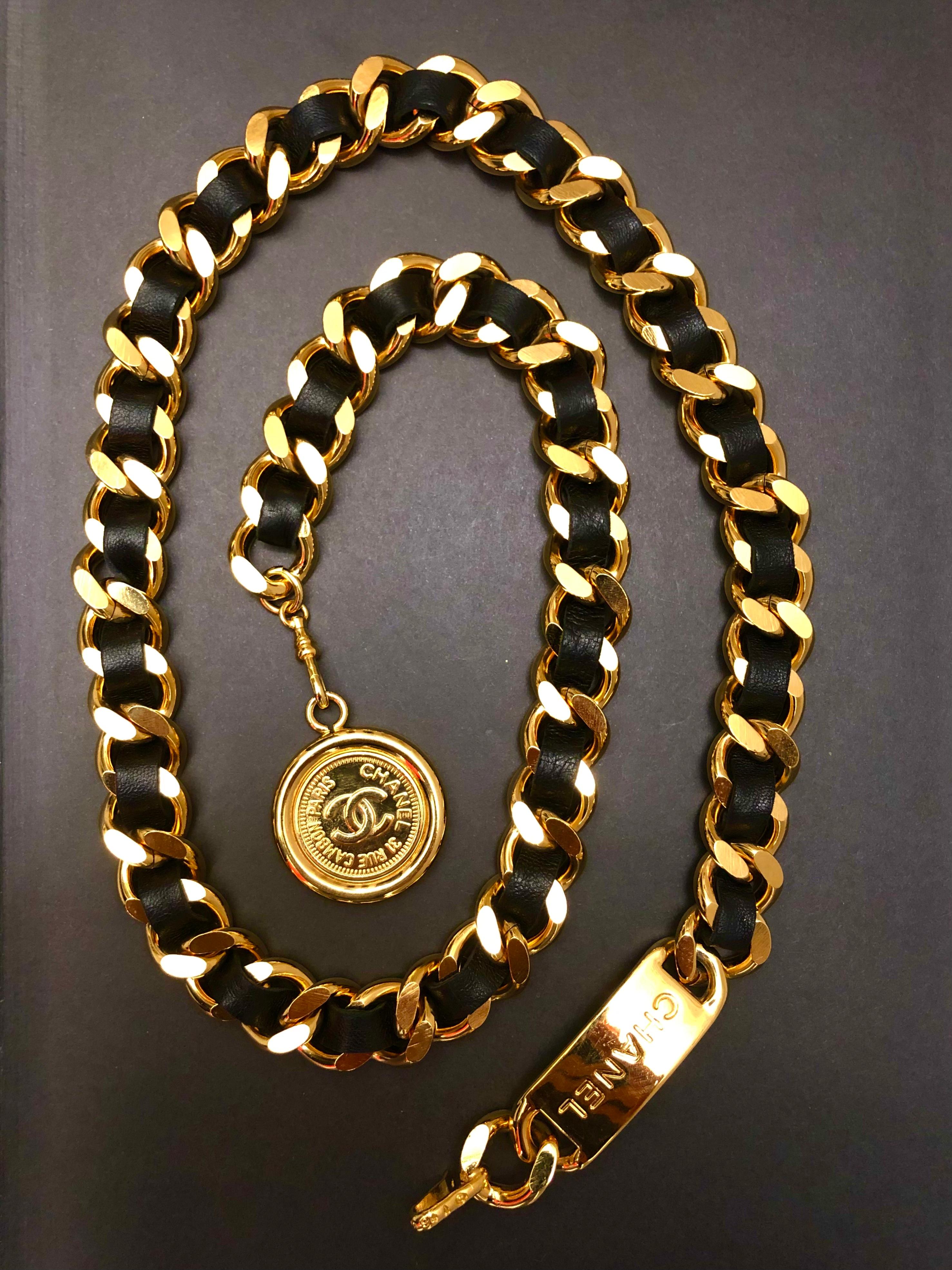 This vintage CHANEL chain belt is crafted of sturdy gold toned chain interlaced with black leather featuring a Cambon coin charm. Stamped 94A CHANEL. Chain length excluding coin measures approximately 81 cm (32 inches) width 1.2 cm. Comes with box.