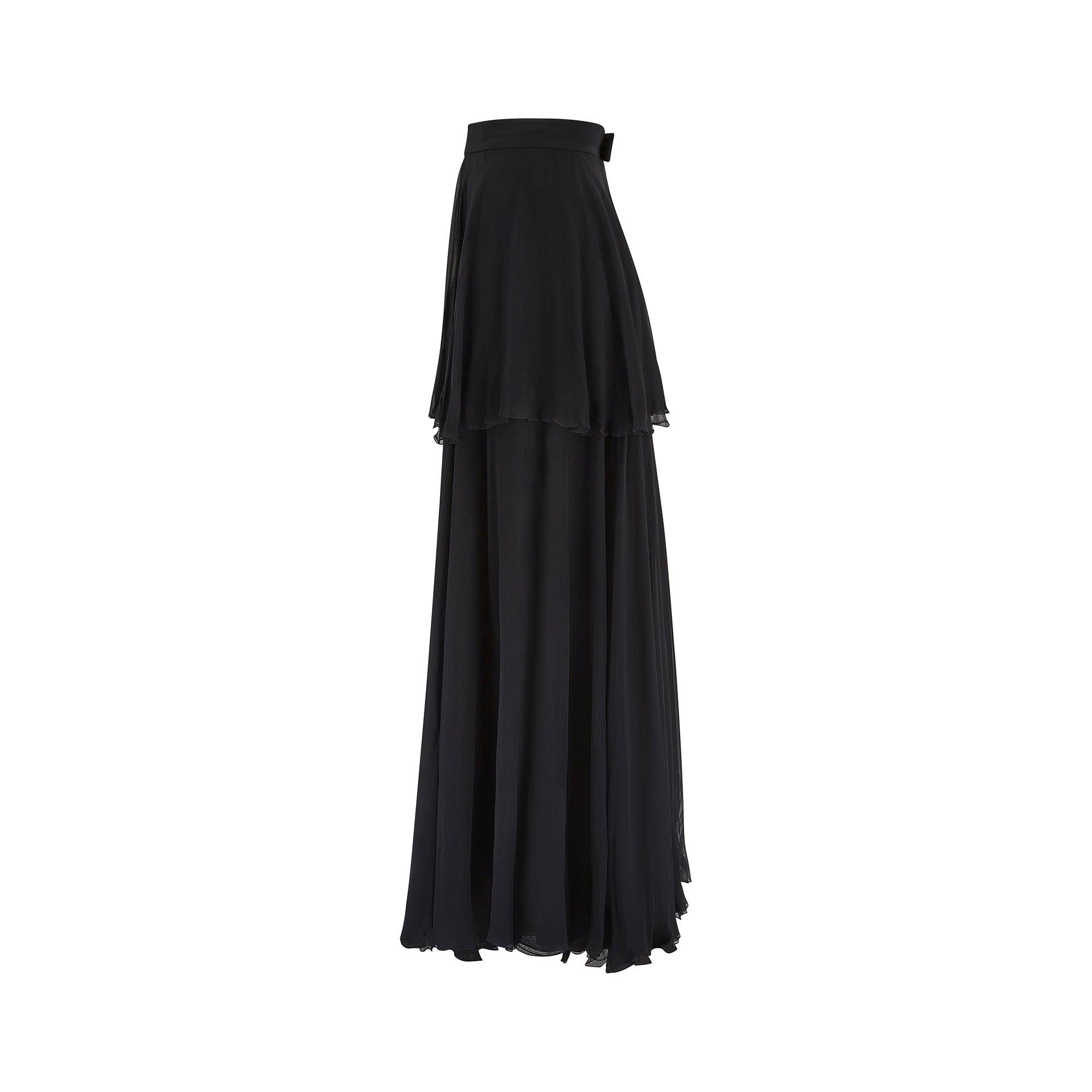 This elegant, black silk chiffon skirt was designed by Karl Lagerfeld for Chanel in the 1990s. Bringing the brand’s timeless sophistication to a floaty maxi-skirt style, this piece is cut with a flattering high waist and free-flowing silhouette. The