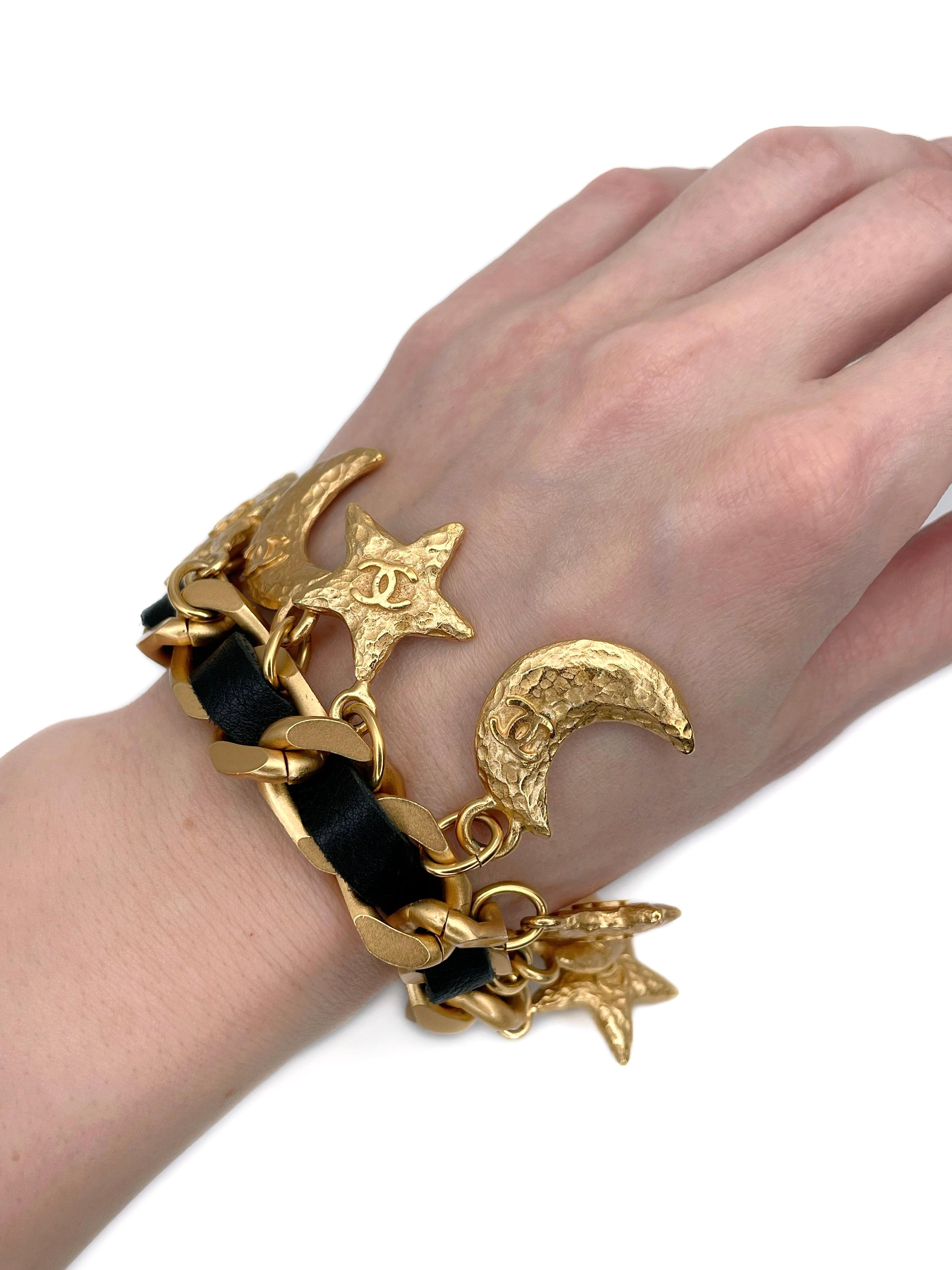 This is a vintage moon and star CC logo charm bracelet. The piece is designed by Chanel in 1990s. 

It is crafted in base metal and is gold plated. The bracelet features black leather. 

Signed: “© Chanel ® - 95A - Made in France” (see photo