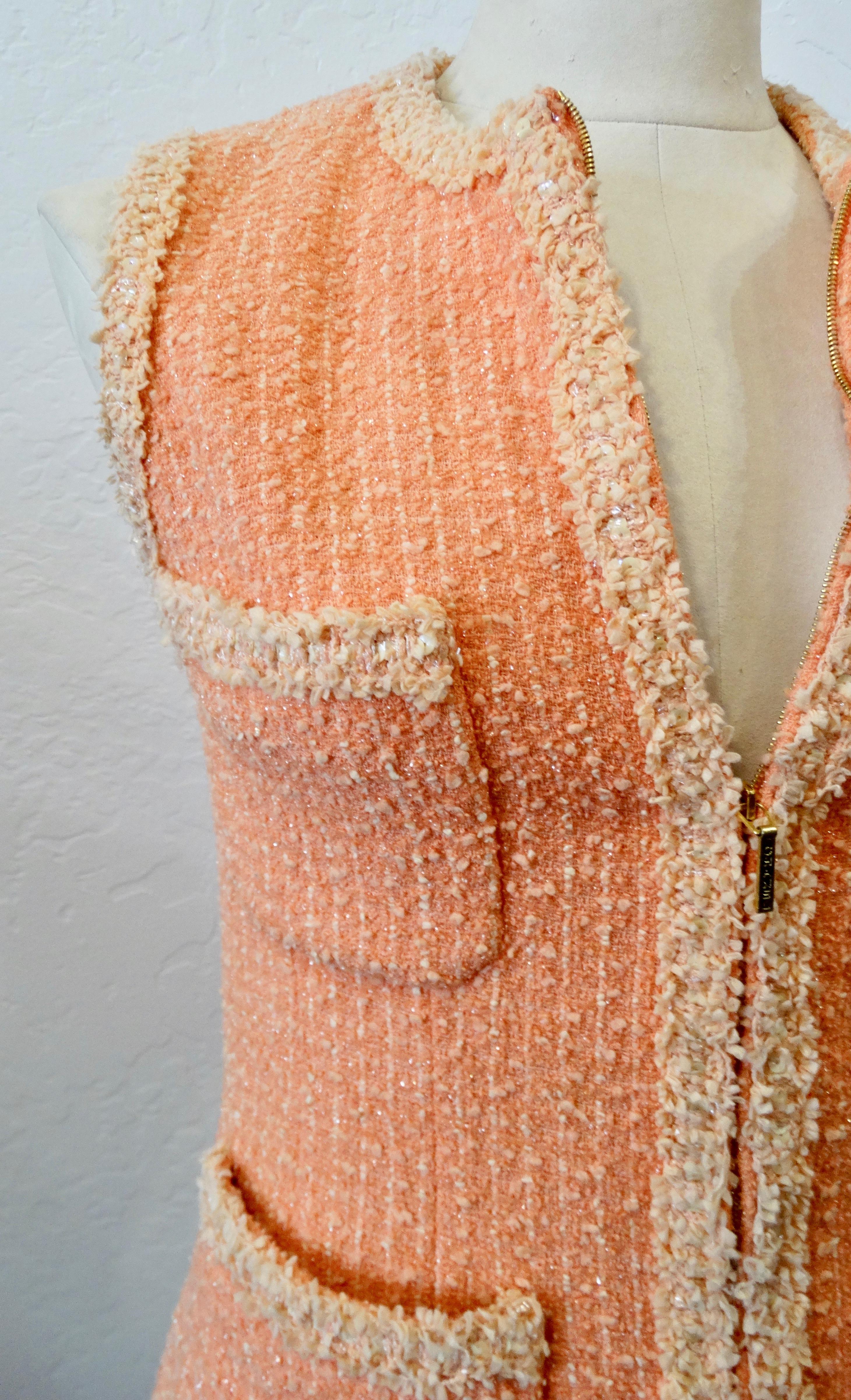 It doesn't get any better than 1990s Chanel by Karl Lagerfeld himself! Circa 1995, this adorable wool tweed vest is a great overall peach color intertwined with a contrasting light peach and subtle silver metallic thread. The light peach color is