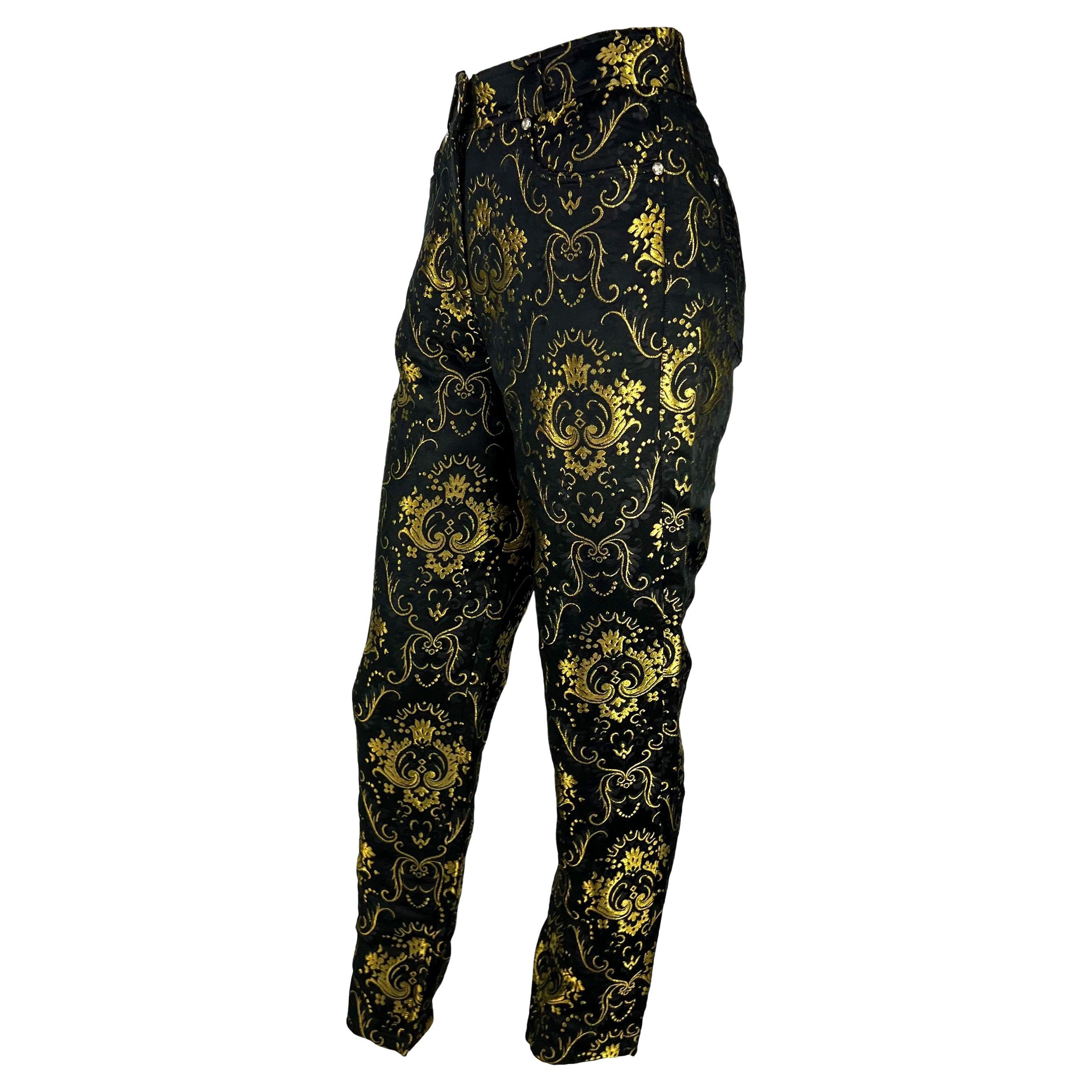 Presenting a fabulous pair of baroque Gianni Versace Couture pants, designed by Gianni Versace. From 1995, these black and gold brocade pants feature a bold baroque pattern and a silver Versace Medusa button closure and rivets. Never before worn,