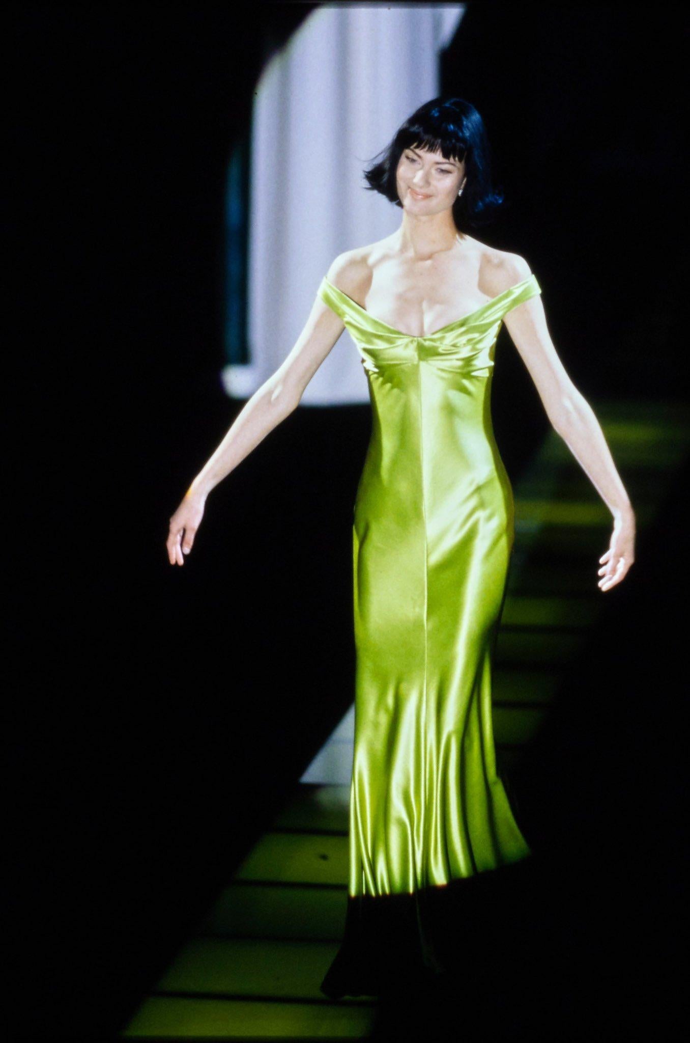 A well documented and highly coveted Gianni Versace chartreuse green off-shoulder hourglass gown dating back to his iconic 1995 fall-winter collection. Versace’s creations were enjoyed by the super wealthy but his impact was felt across a wider