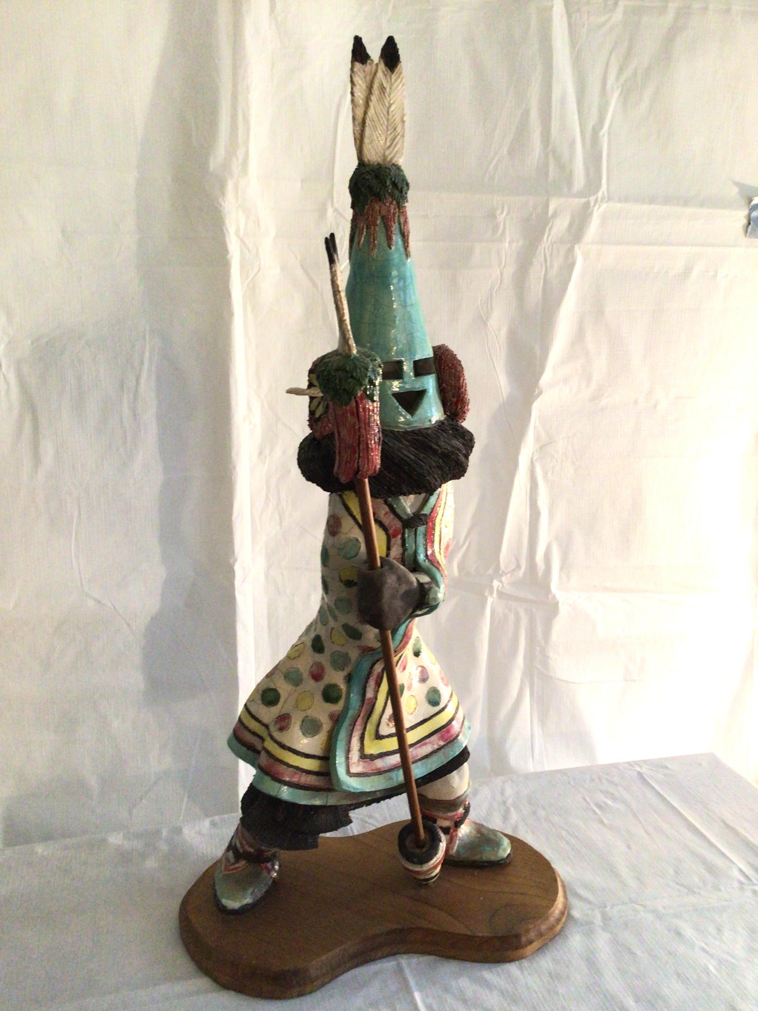 1995 Hopi Kachina Doll - Aholi on wood base
Matte and Glazed in ceramic (heavy)
Feather missing on one ear muff 
The perfect addition to any Kachina Doll collection.