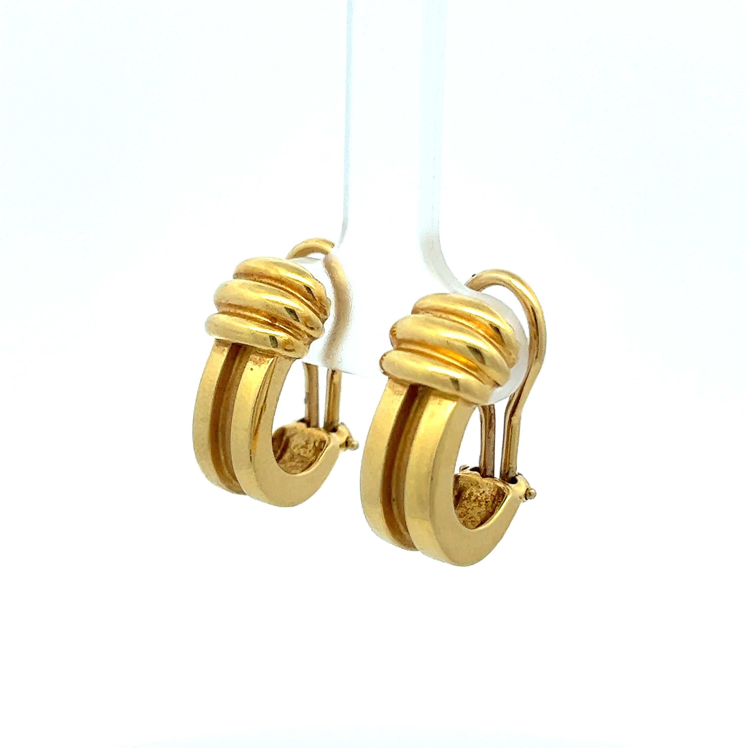 These 18 karat yellow gold clip-on huggie earrings hail from Tiffany & Co.'s esteemed Atlas collection, dating back to 1995. Characterized by the iconic numeral motifs, the Atlas collection draws inspiration from the Atlas clock that has adorned the