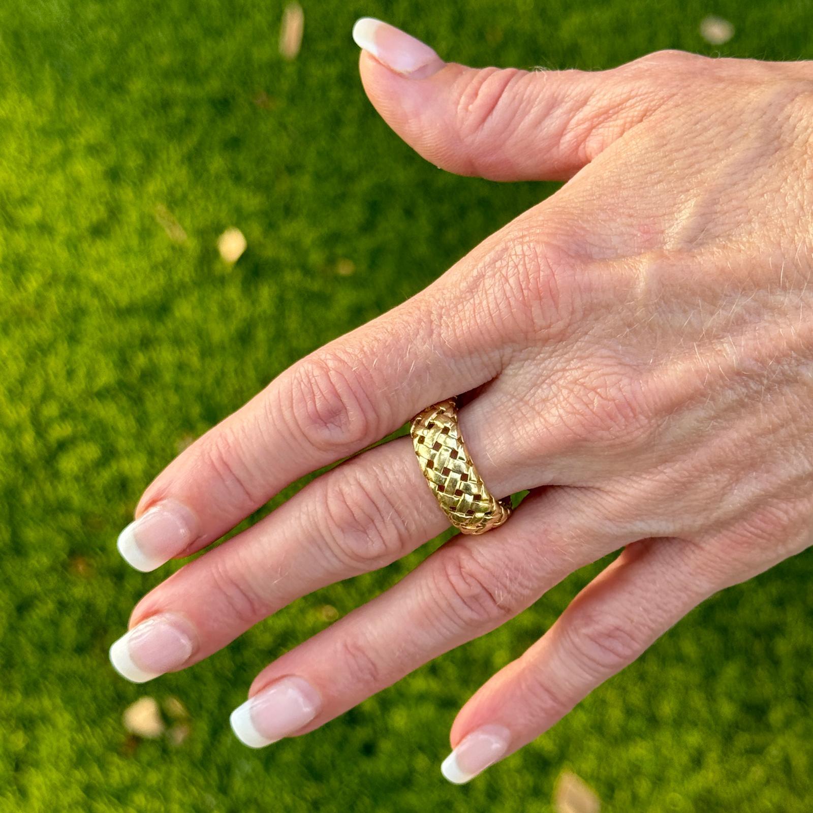 Tiffany & Company vintage band ring features a unique basket weave design that adds texture and dimension to the band. Crafted in 18 karat yellow gold with meticulous attention to detail, the ring measures 8.6mm in width and is size 8. Weight: 9.1