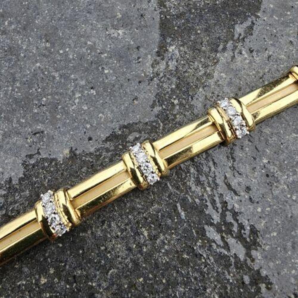 This exquisite vintage bracelet from Tiffany & Co. is a true gem. Crafted from 18k gold platinum, it boasts a stunning diamond design that is sure to catch the eye of any jewelry lover. The bracelet is lined and weighs heavily, adding to its