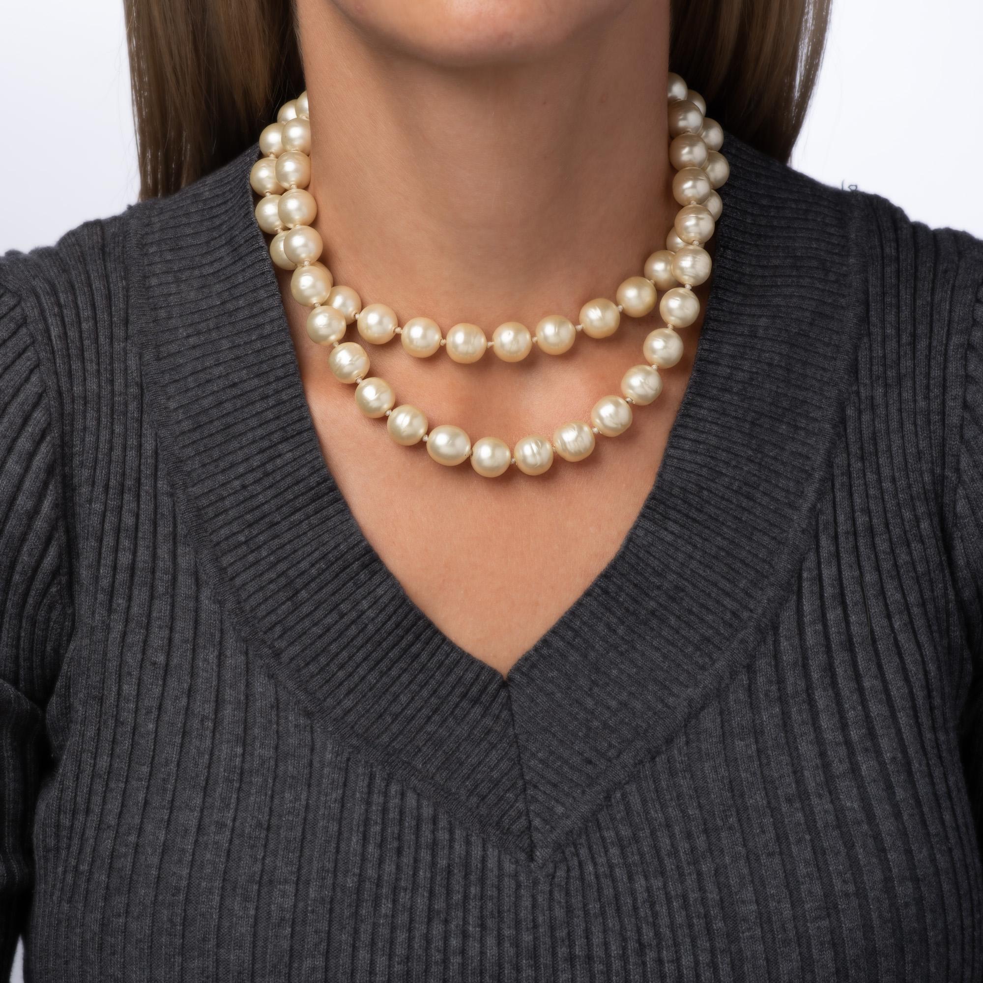 Vintage Chanel double-strand choker necklace finished with a crystal and blue stone textured Gripoix clasp (circa 1995). 

The necklace features 12mm faux pearls of irregular shape with a crystal and blue stone set Gripoix clasp. Measuring 16 inches