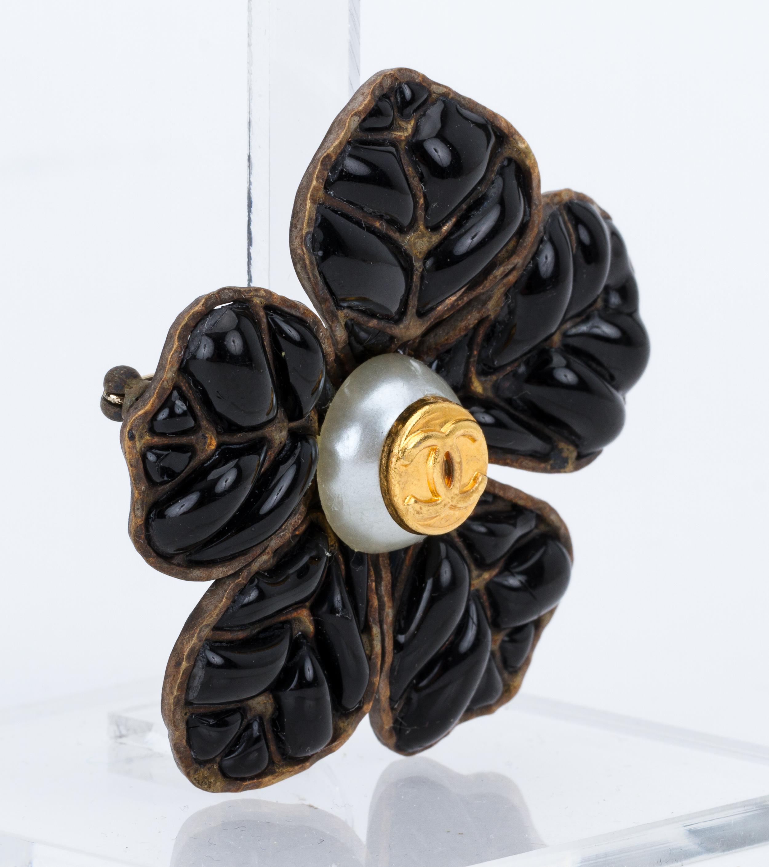 Chanel gripoix black camellia pin . Handmade poured glass with pearl center. Autumn 95 collection. Comes with original box .