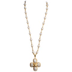 1995A Chanel long beaded necklace with its cross-shaped pendant
