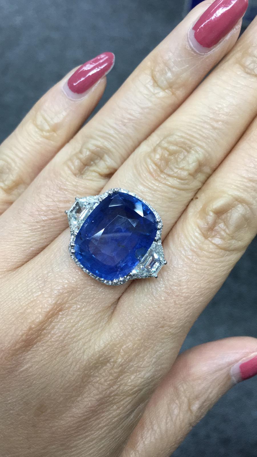 Primary Stone: Sapphire ( Sri Lanka )
Shape : Cushion Cut
Sapphire Weight: 19.95 Carats 
Measurements Sapphire: 17.53mm x 3.61mm x 8.00mm
Color: Vivid Blue
Average Clarity: 
Accent Stones: Genuine Diamond
Shape Or Cut Diamond: 2 Trapeze 1.63 ct and