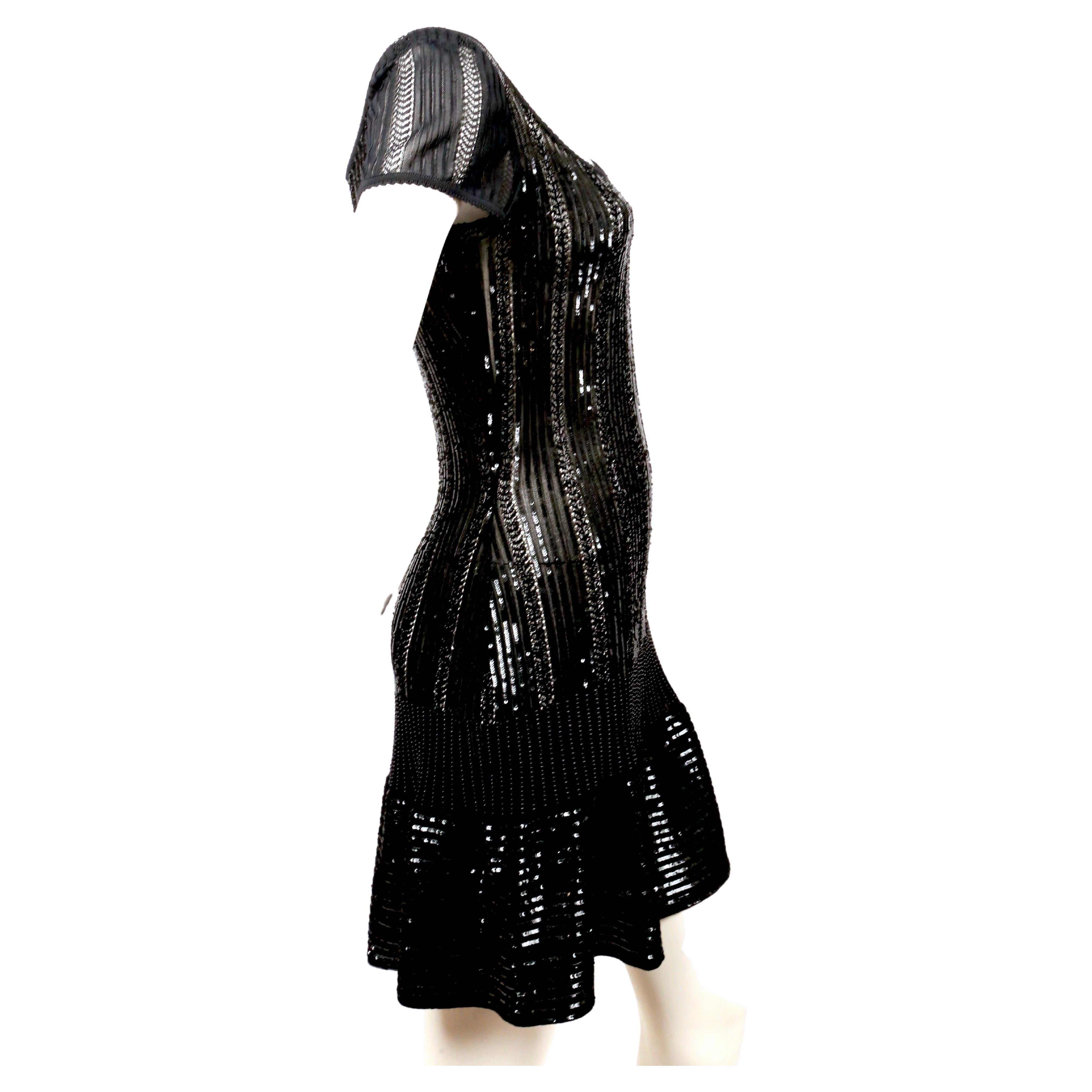 Jet-black beaded and micro-sequined mini dress designed by Azzedine Alaia dating to spring of 1996. Dress is labeled a size S. Length is approximately 33