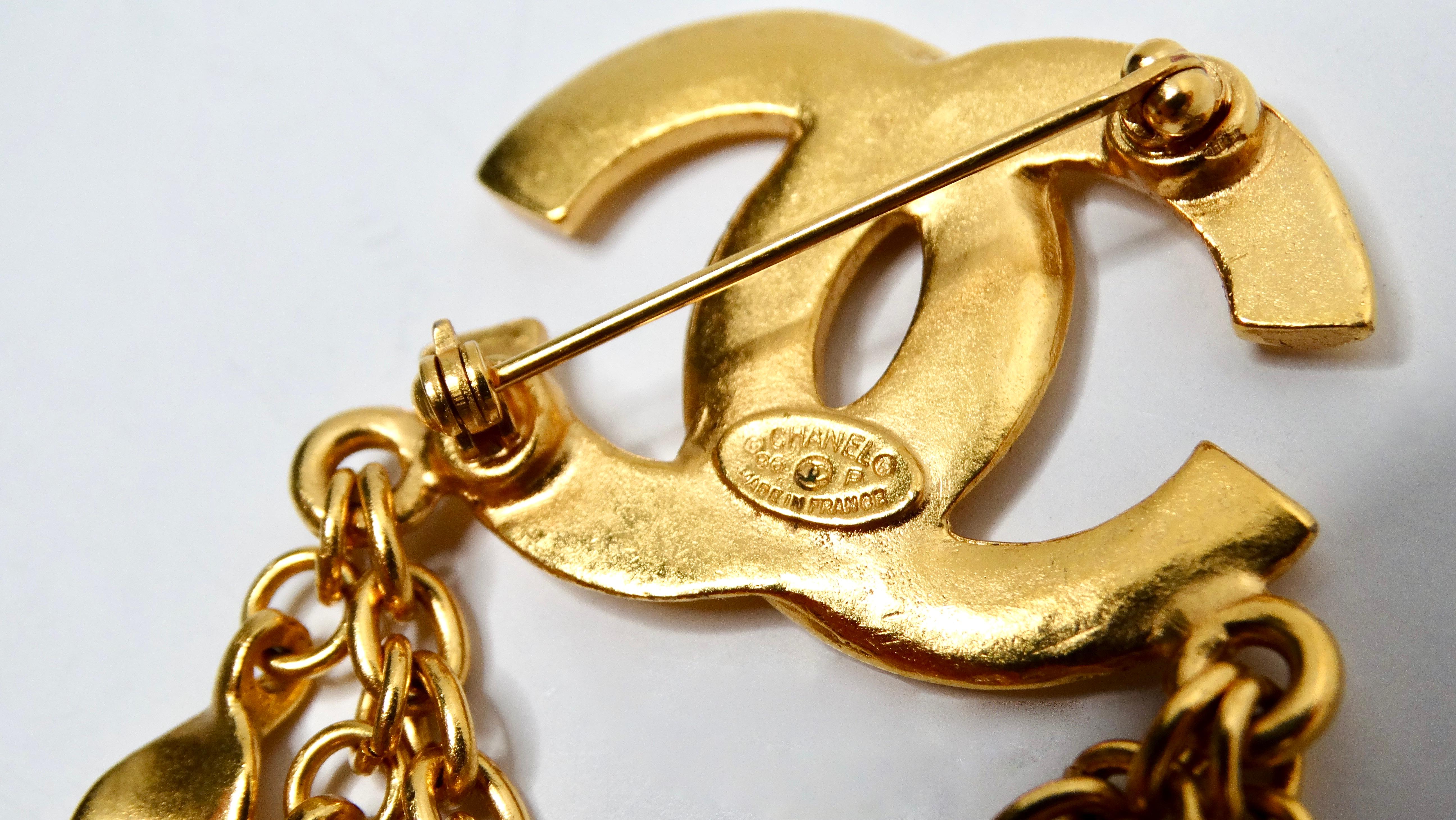 Women's or Men's 1996 Chanel Coco Mark Yellow Gold-Tone Brooch With Dangling Charms For Sale
