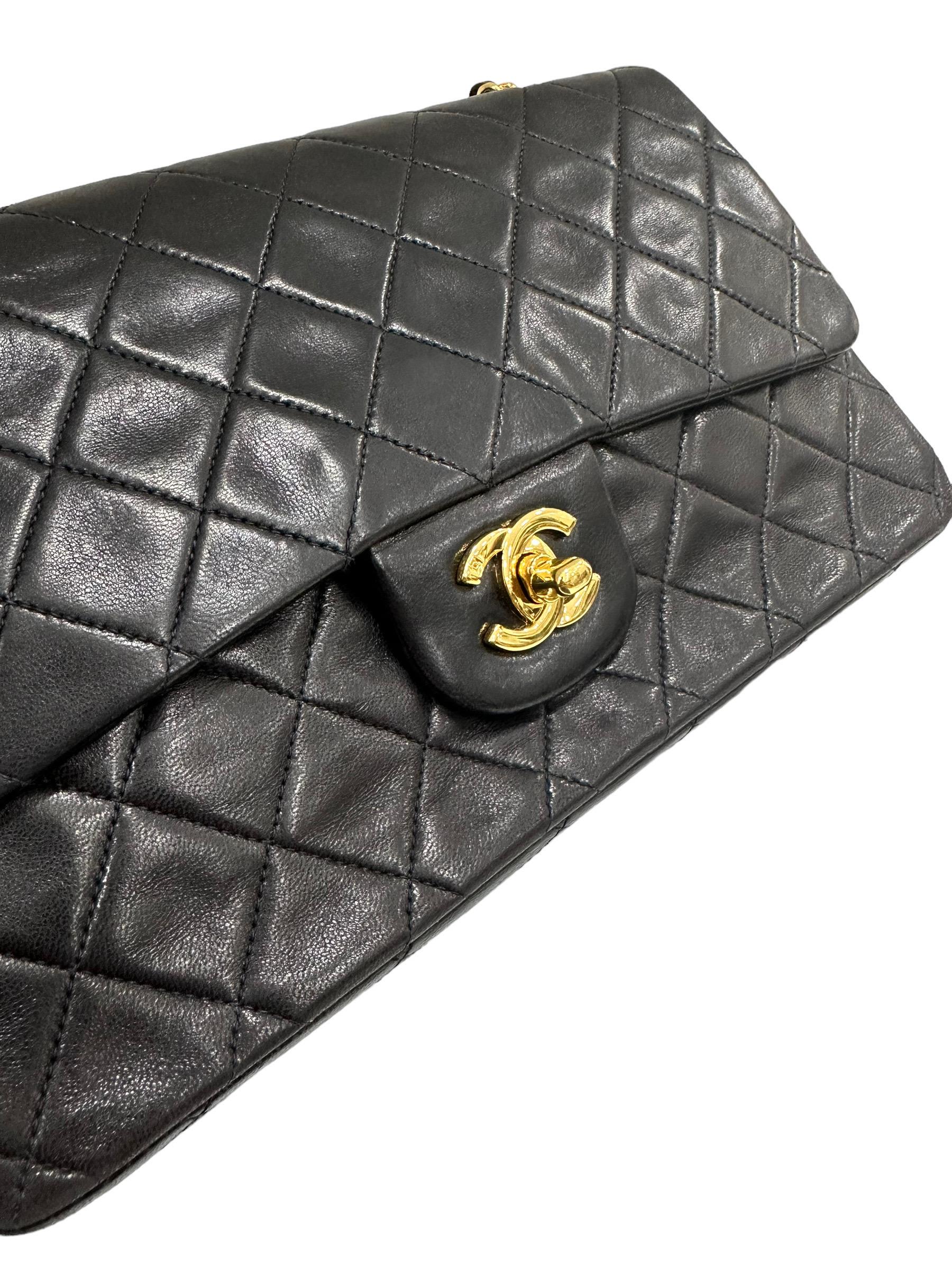 

Classic bag signed Chanel, Timeless line, model 2.55, made in black leather with gold gardware. Equipped with double flap, the upper one with turn lock closure with CC logo, the internal one with button closure. Equipped with a sliding shoulder