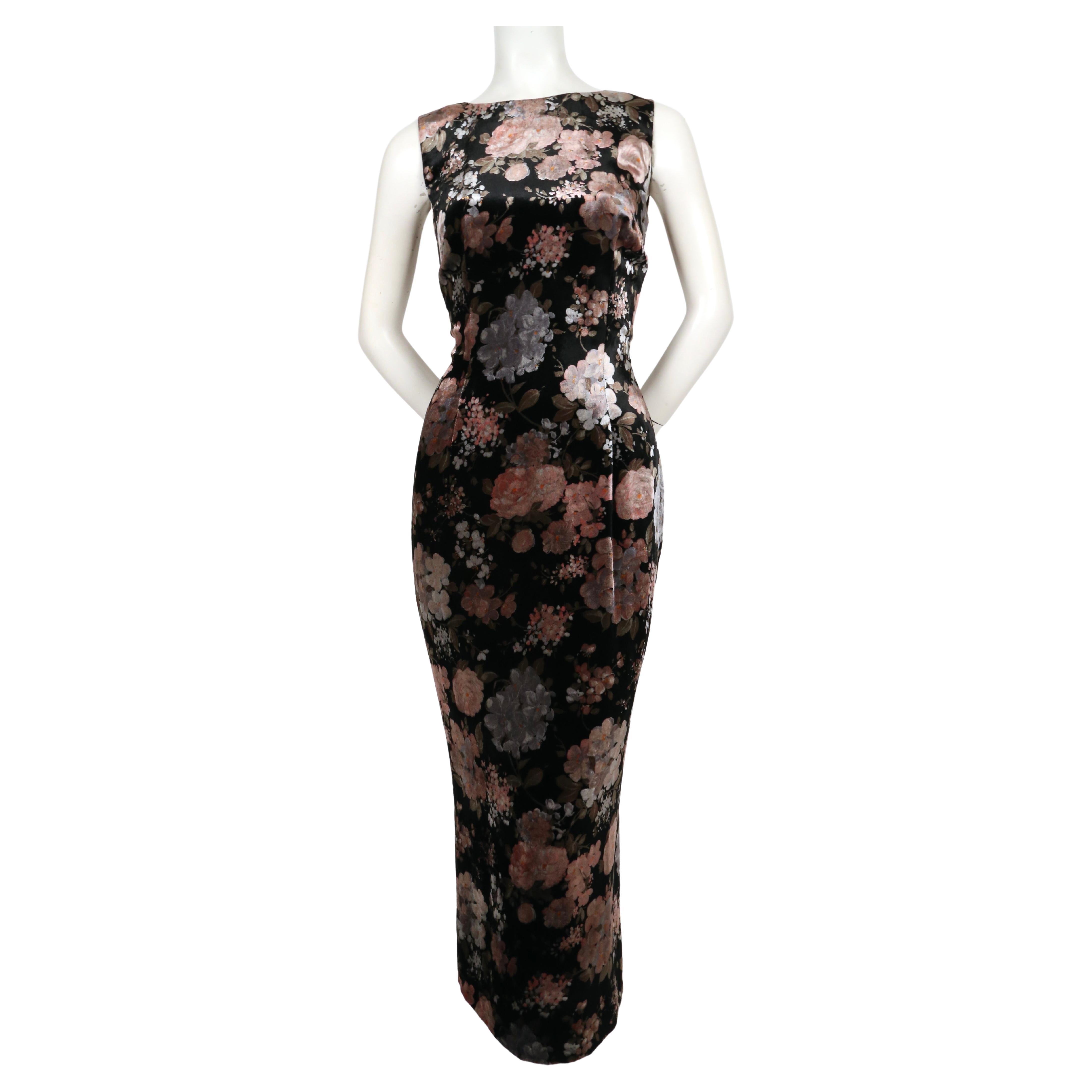 Long, floral velvet dress from Dolce & Gabbana dating to fall of 1996. Colors have a slightly metallic sheen to them. Dress has a very flattering figure hugging fit with a deep V at back and slit at center back hem. Italian size 42. Approximate
