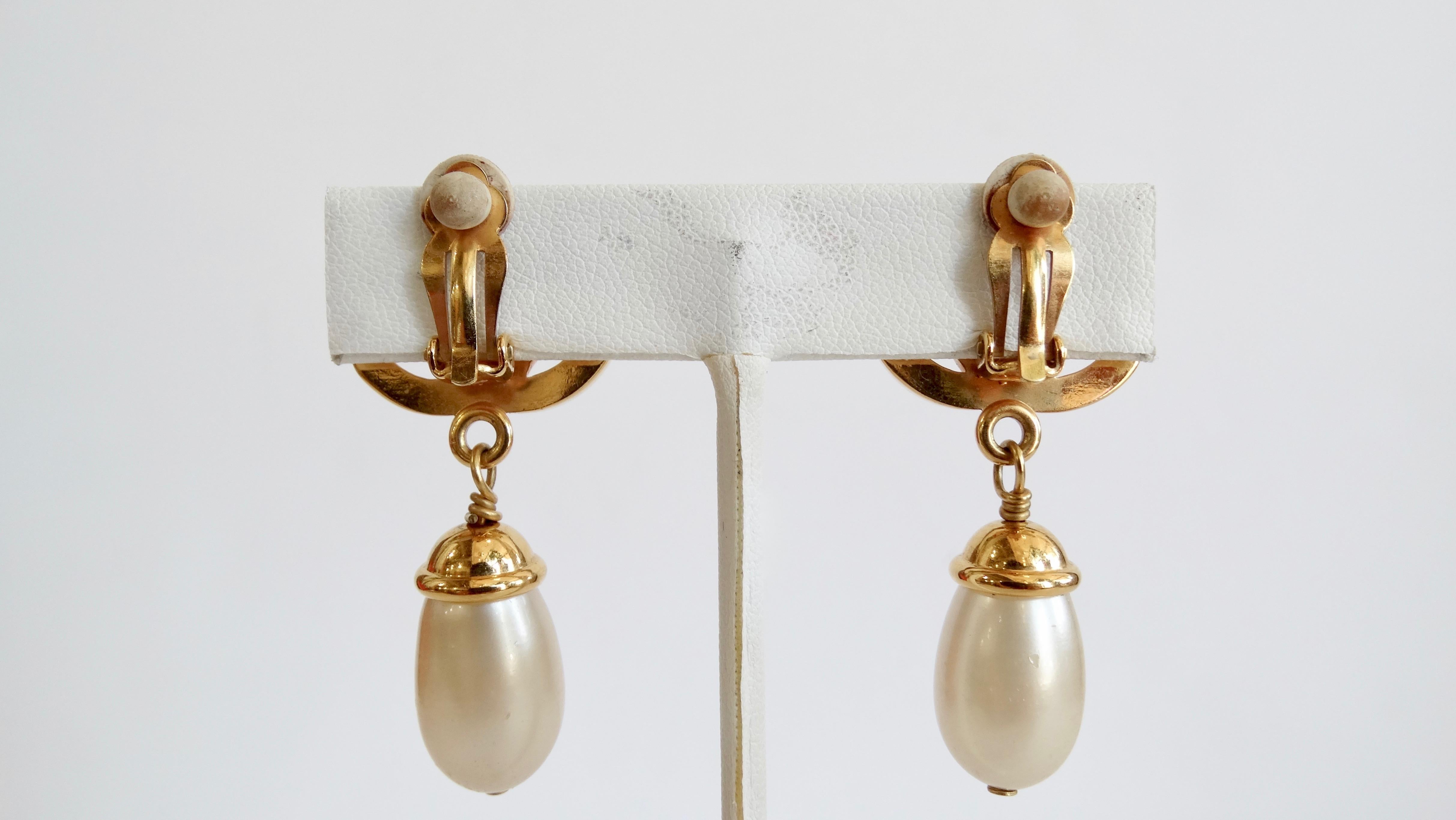 Everyone needs a great piece of vintage Chanel jewelry in their collection! Circa 1996 from their Fall/Winter collection, these gilded metal Chanel drop earrings feature the iconic CC mademoiselle turn-lock encrusted with Swarovski crystals and a