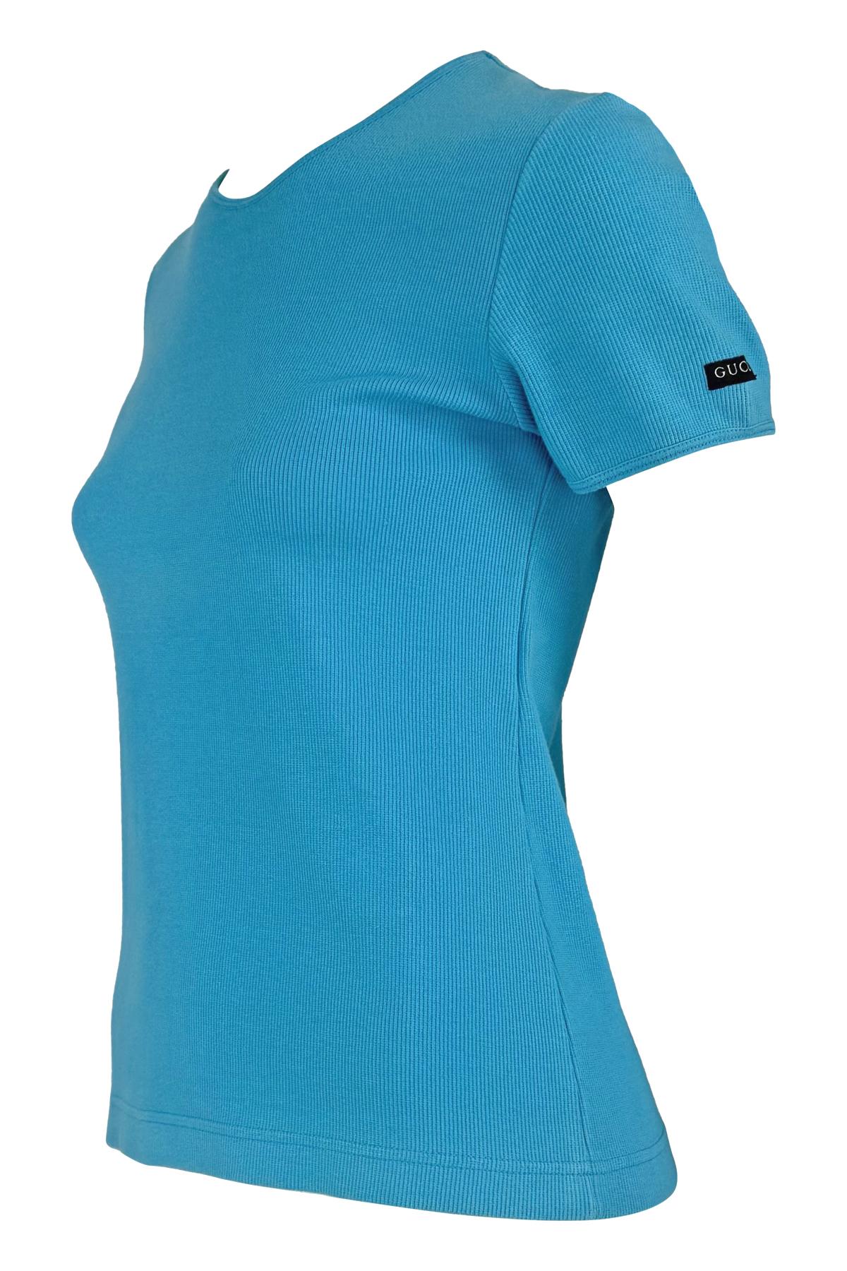 From Gucci's 1996 collections under Tom Ford, this bright blue ribbed stretch t-shirt offers a sleek, form-fitting silhouette. The design features a subtle black Gucci logo patch on the sleeve, adding an elevated touch to this classic crewneck