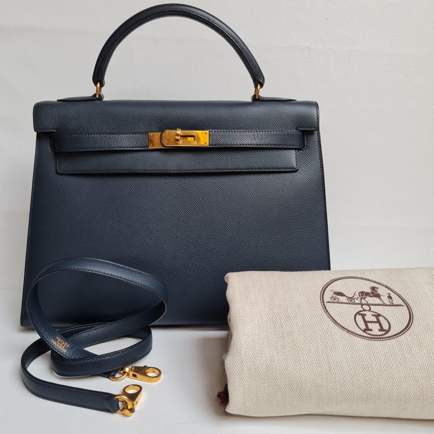 Classic 1996 Kelly 32 Bag in Navy Epsom leather. Beautiful condition, only minor scratches due to wear and some tarnishing on the bottom feet hardware. Item is missing its clochette. Only comes with it strap. Overall in great condition as pictured. 