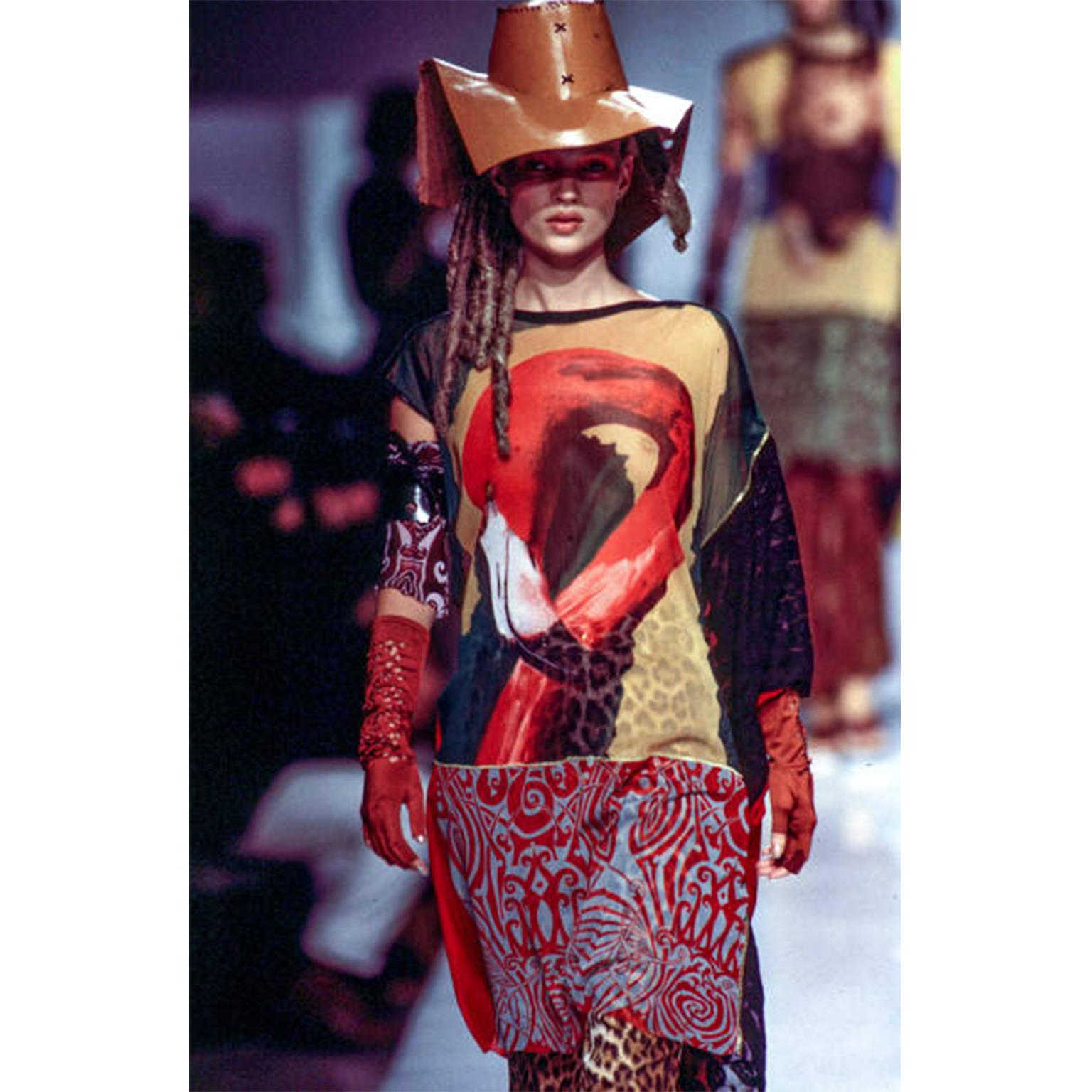 This fabulous vintage Jean Paul Gaultier jacket or top features a bold flamingo print that can be seen on the front, back and both sleeves. The top can be worn like a jacket and has a gold collar and a center front zipper closure with a green loop