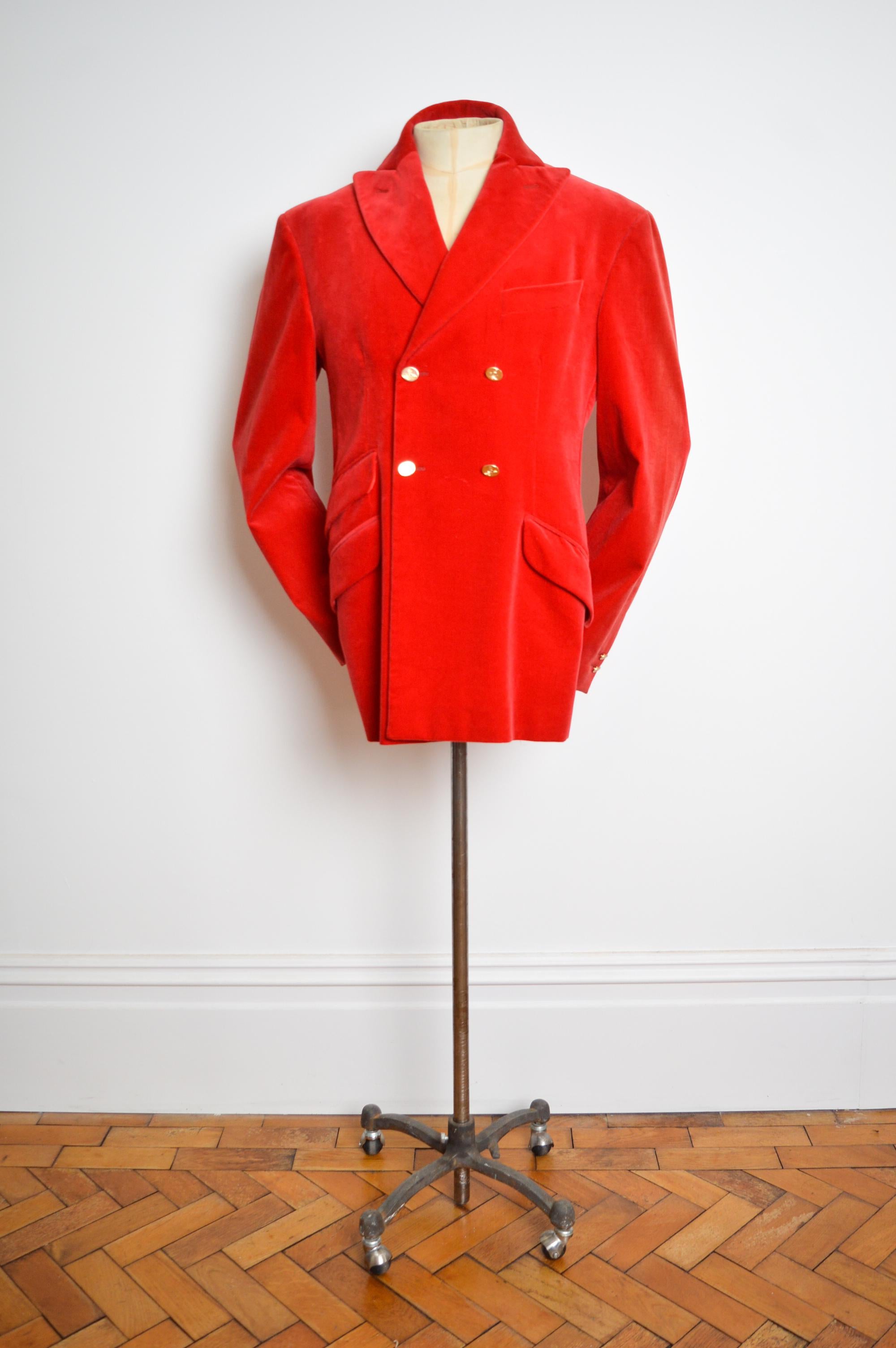 Superb vintage Vivienne Westwood scarlet red velvet double breasted Jacket.

This remarkable Westwood jacket features the instantly recognisable Gold 'Orb' buttons, a simple yet beautifully tailored cut, smooth silvery grey satin lining and the